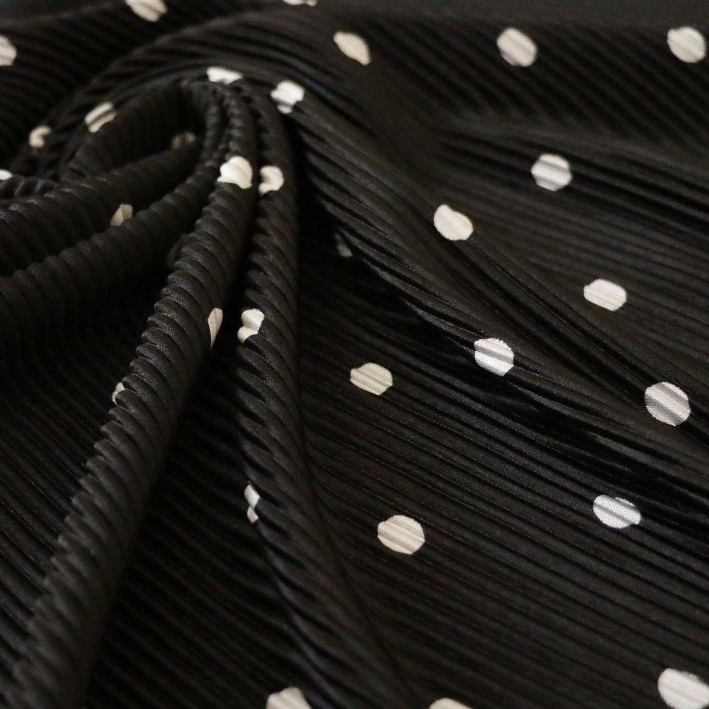 plisse dressmaking fabric with stretch in black and white polka dot design