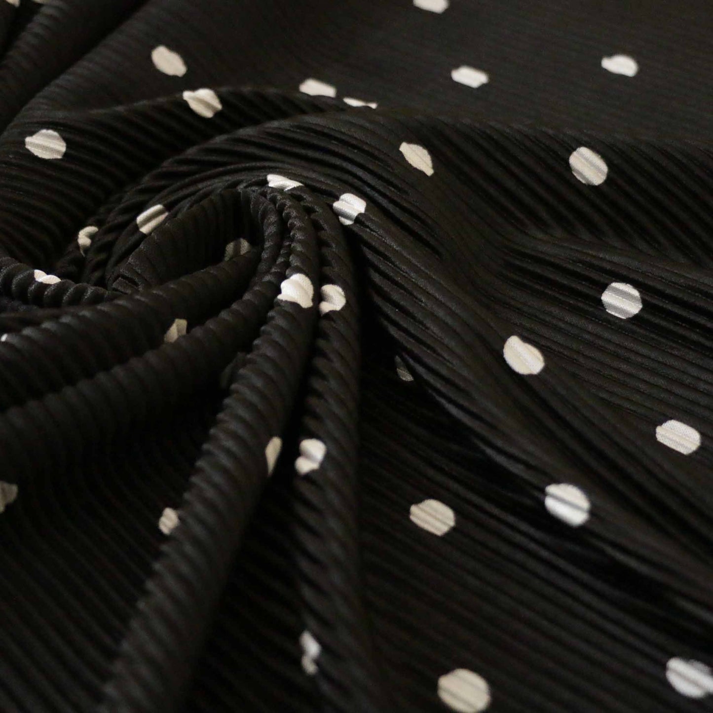 black and white polka dot design stretchy plisse dressmaking fabric
