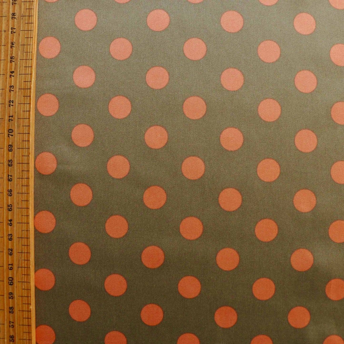 metre beige sating fabric for dressmaking with peach polka dot design
