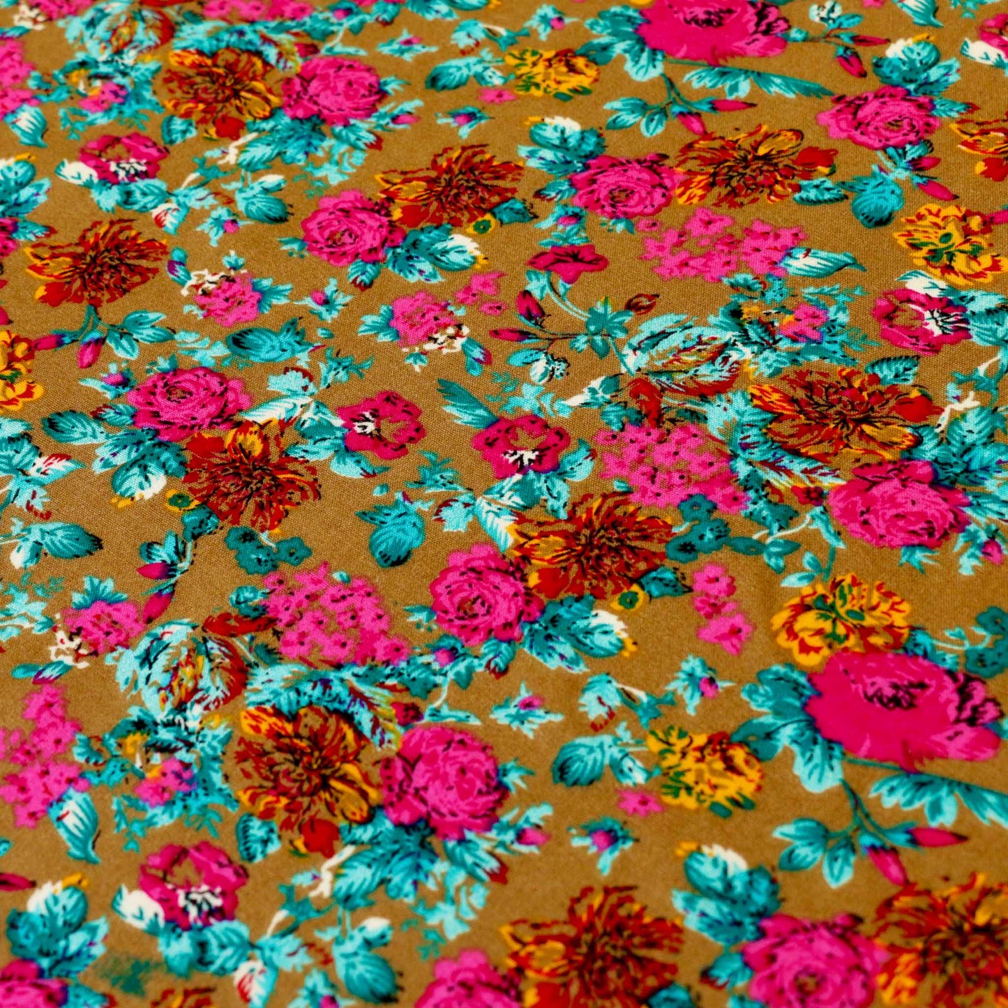 blue and pink flowers printed on golden beige viscose challis rayon dressmaking fabric