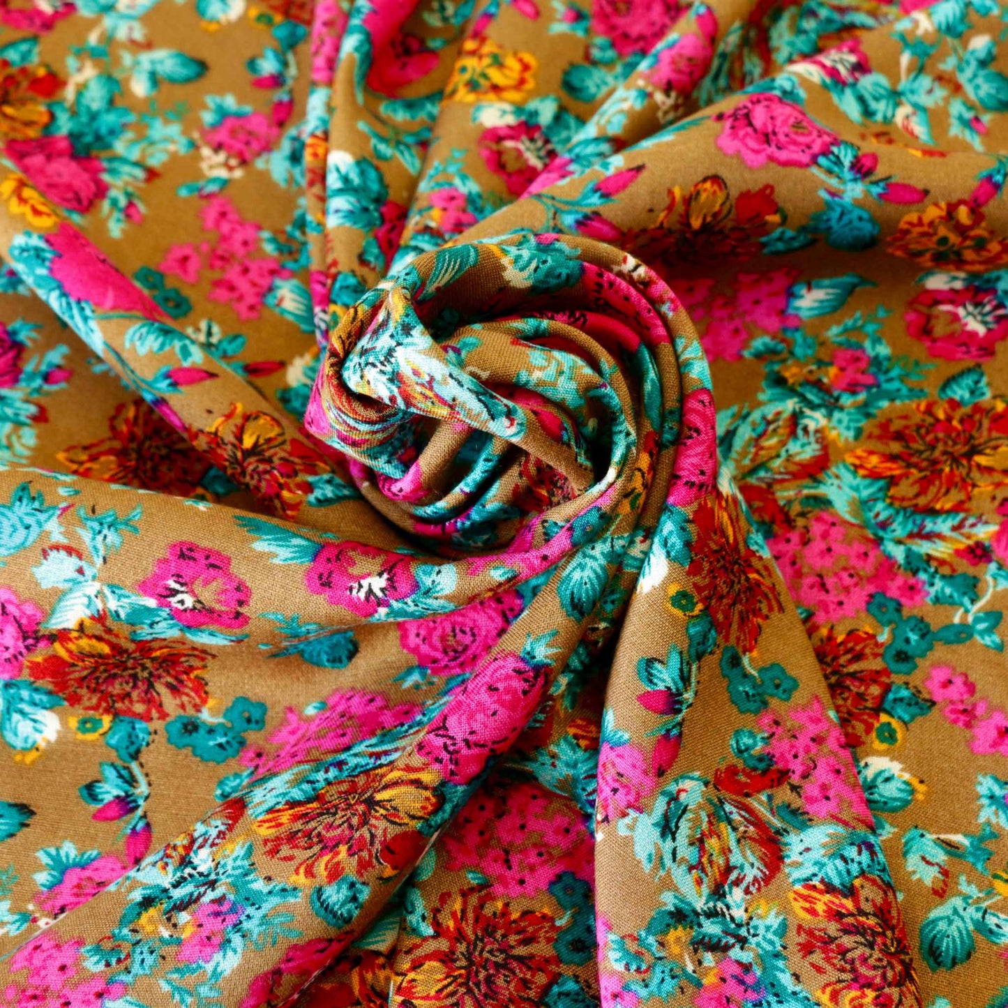 vibrant viscose challis rayon dressmaking fabric with pink and yellow floral print on beige