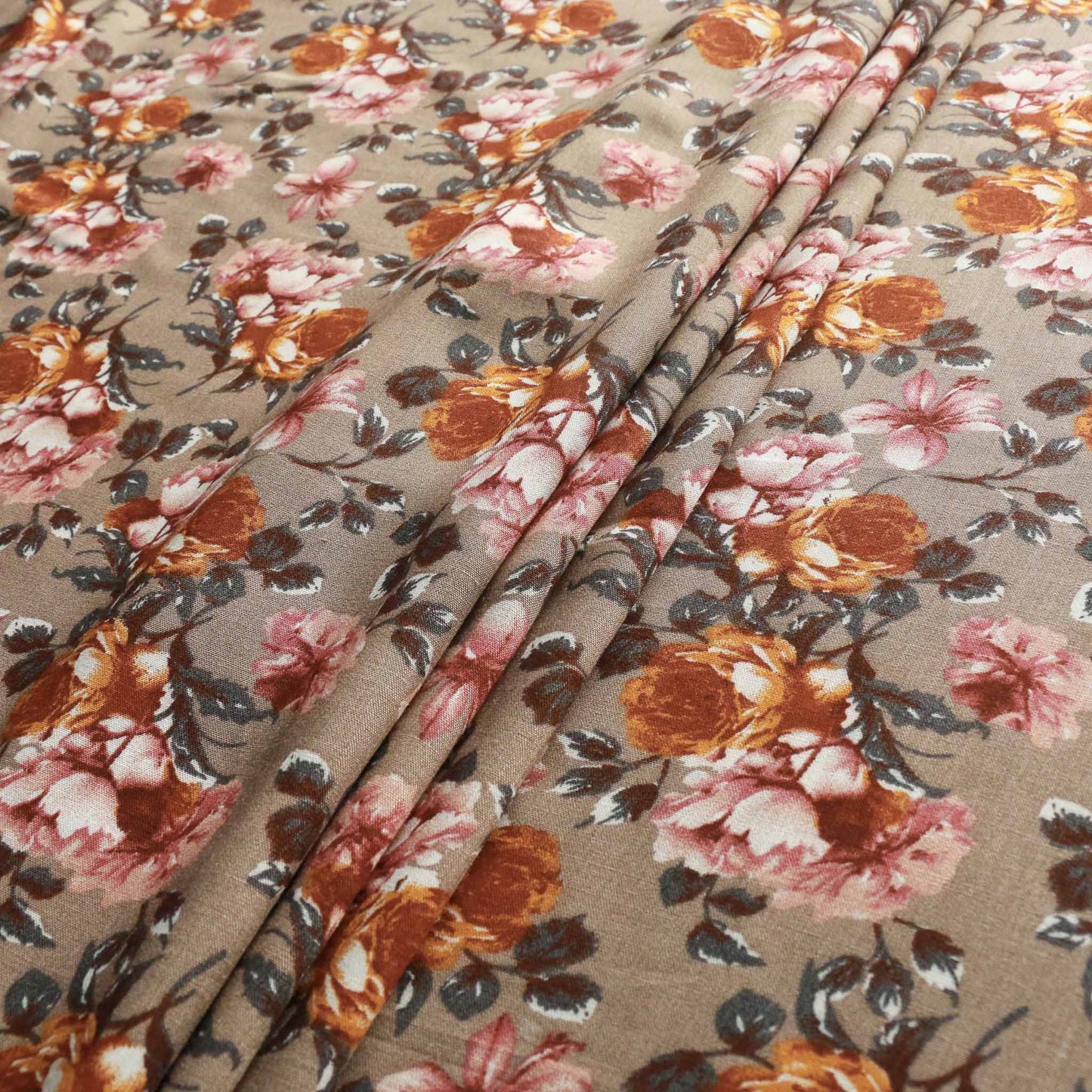 beige viscose challis rayon dressmaking fabric with orange and pink floral design