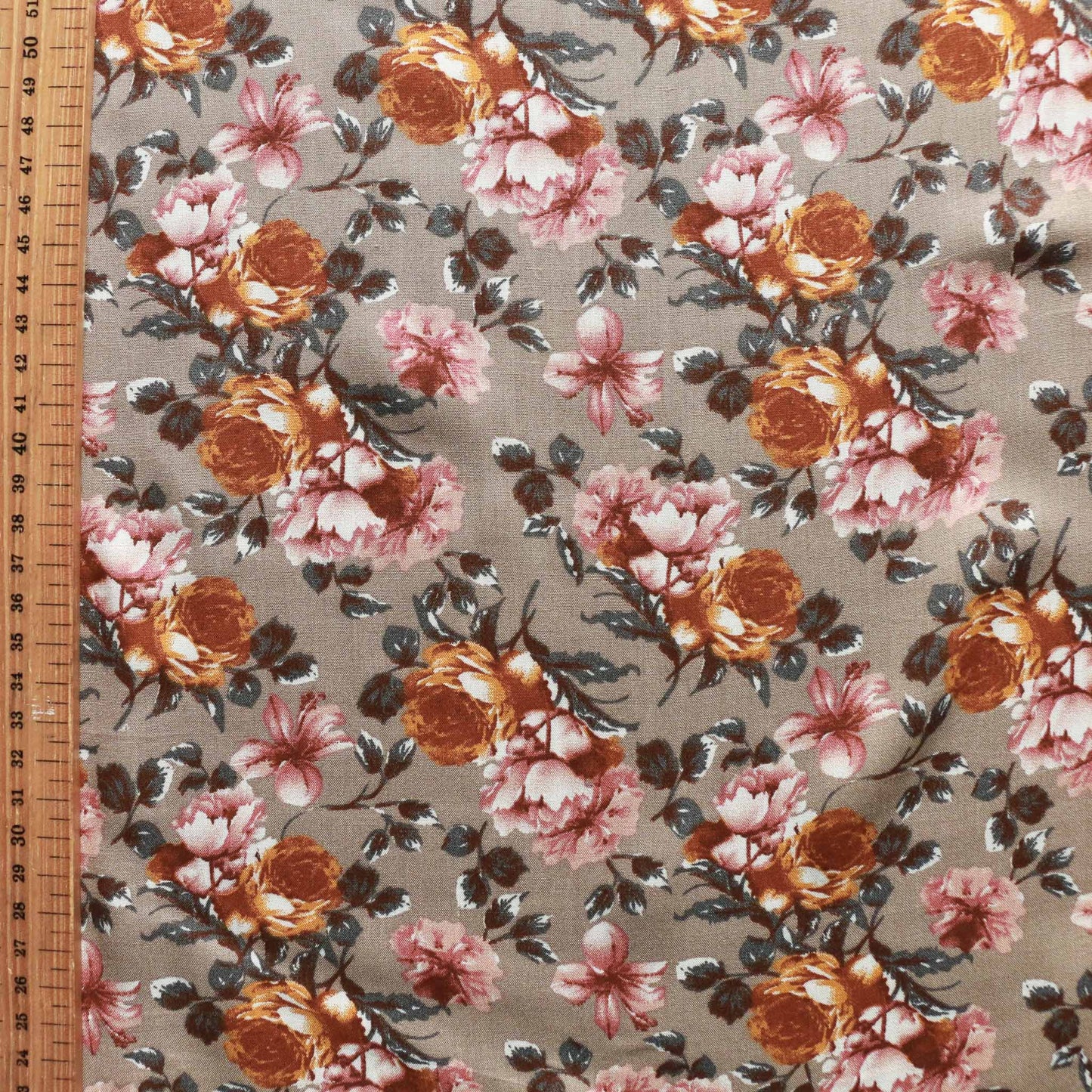 metre beige brown viscose rayon challis dressmaking fabric with earthy coloured flowers