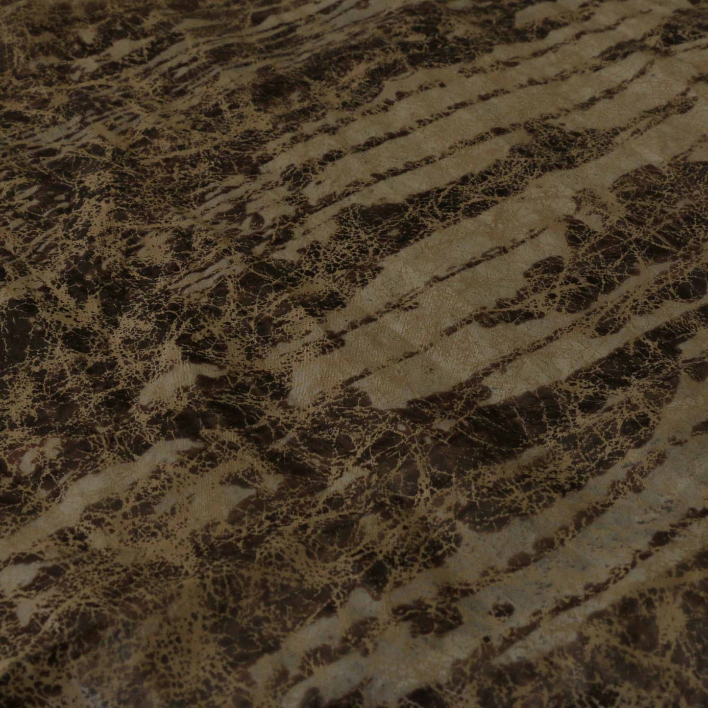 black and gold taffeta dressmaking fabric with worn abstract design