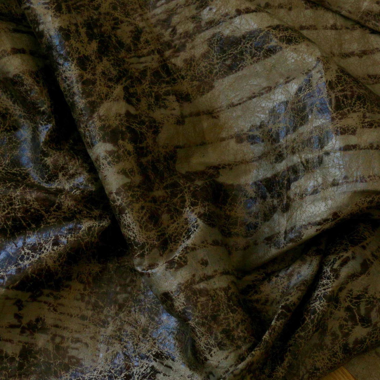 taffeta dressmaking fabric with worn look in gold and black