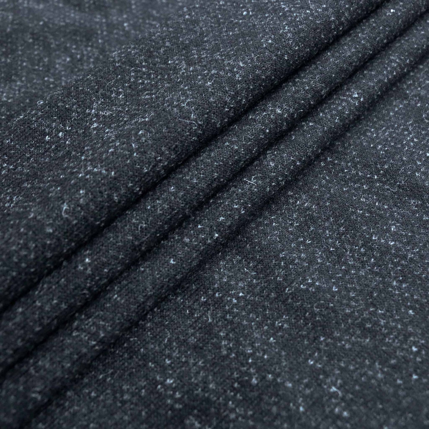 folded jersey wool knit dressmaking fabric with felt back in black and grey
