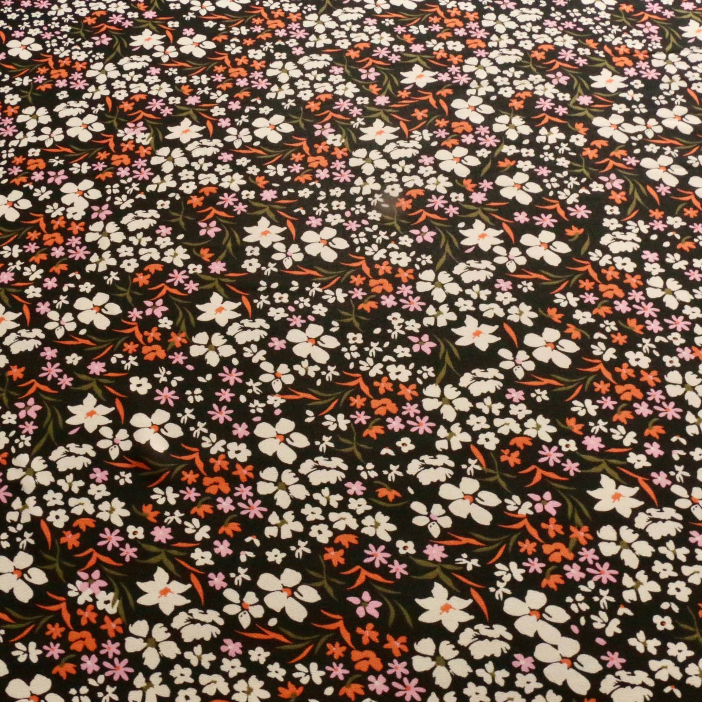 flowery black white and orange viscose chiffon dressmaking fabric