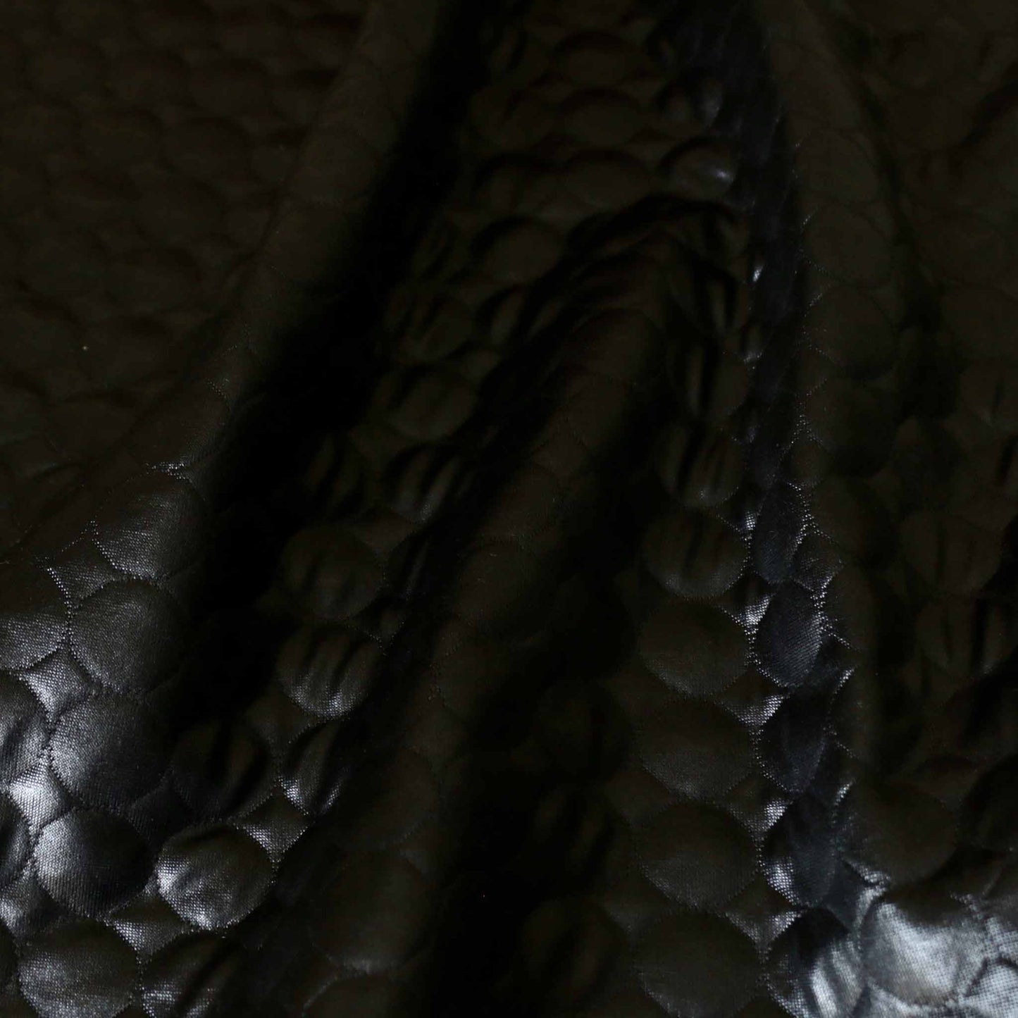 black jersey quilting with glossy texture and circle stitched design