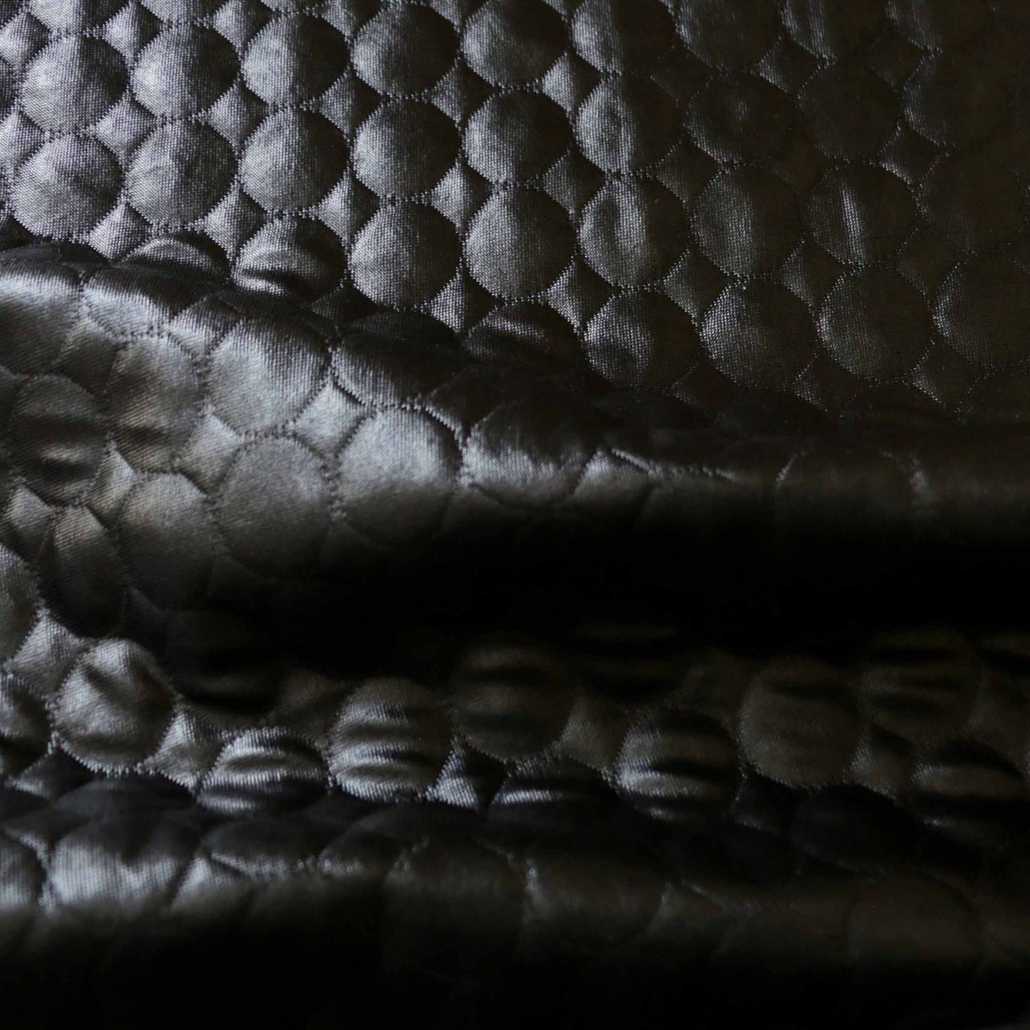 shiny black quilting jersey dressmaking fabric with circle design