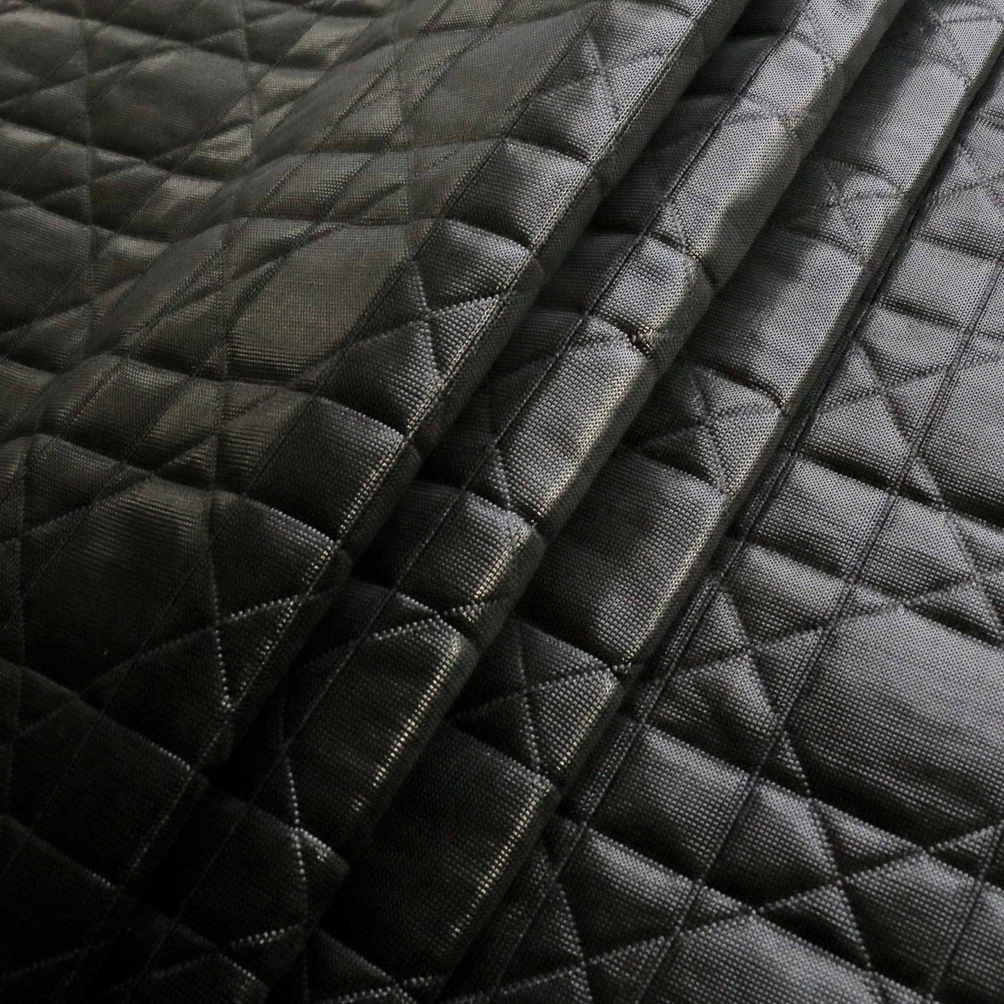 shiny black jersey quilting dressmaking fabric with geometric stitched design