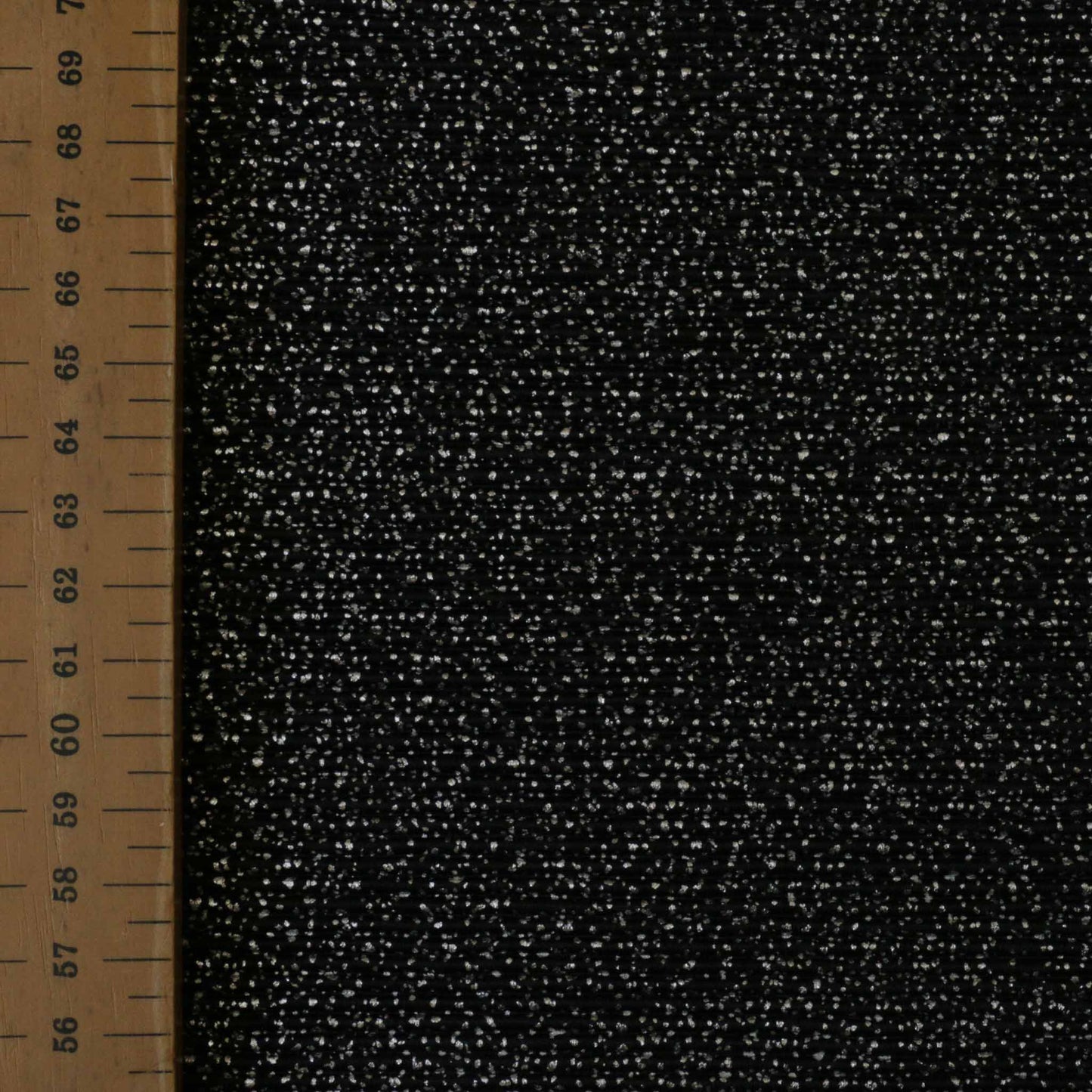 metre black plisse dressmaking fabric with speckled silver shimmer dot pattern