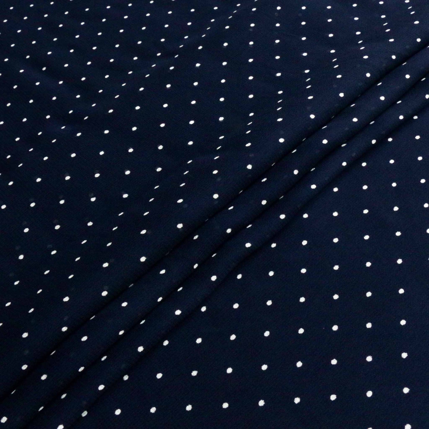 white polka dots on blue viscose chiffon dressmaking fabric