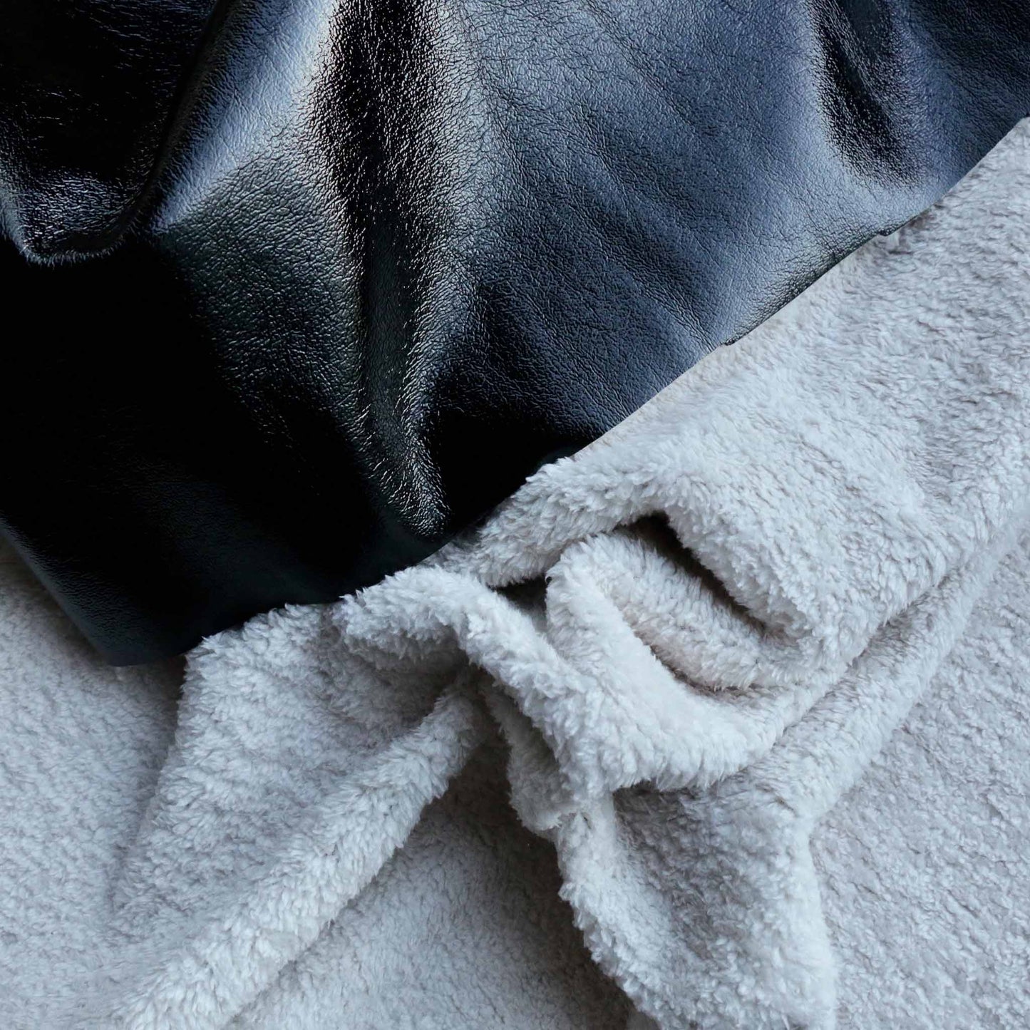 pvc and sherpa fleece bonded dressmaking fabric in black and cream white