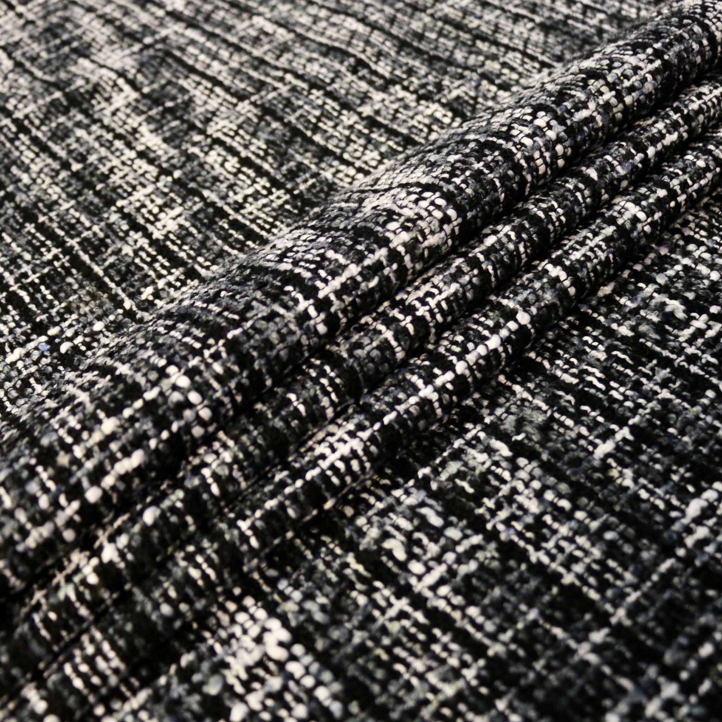 folded black and white wool blend basket weave dressmaking fabric