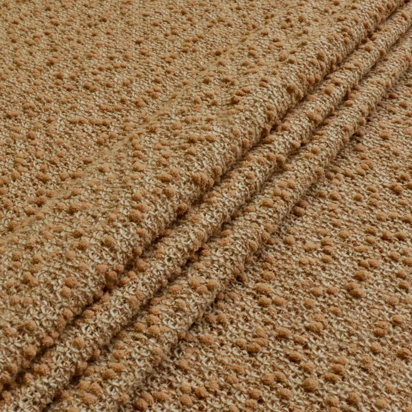 folded brown boucle jersey wool dressmaking fabric