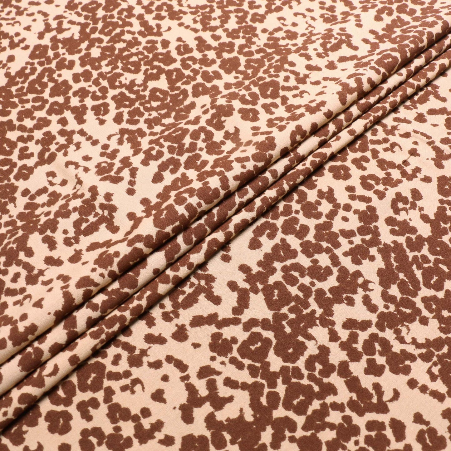 folded brown and beige animal print viscose challis fabric