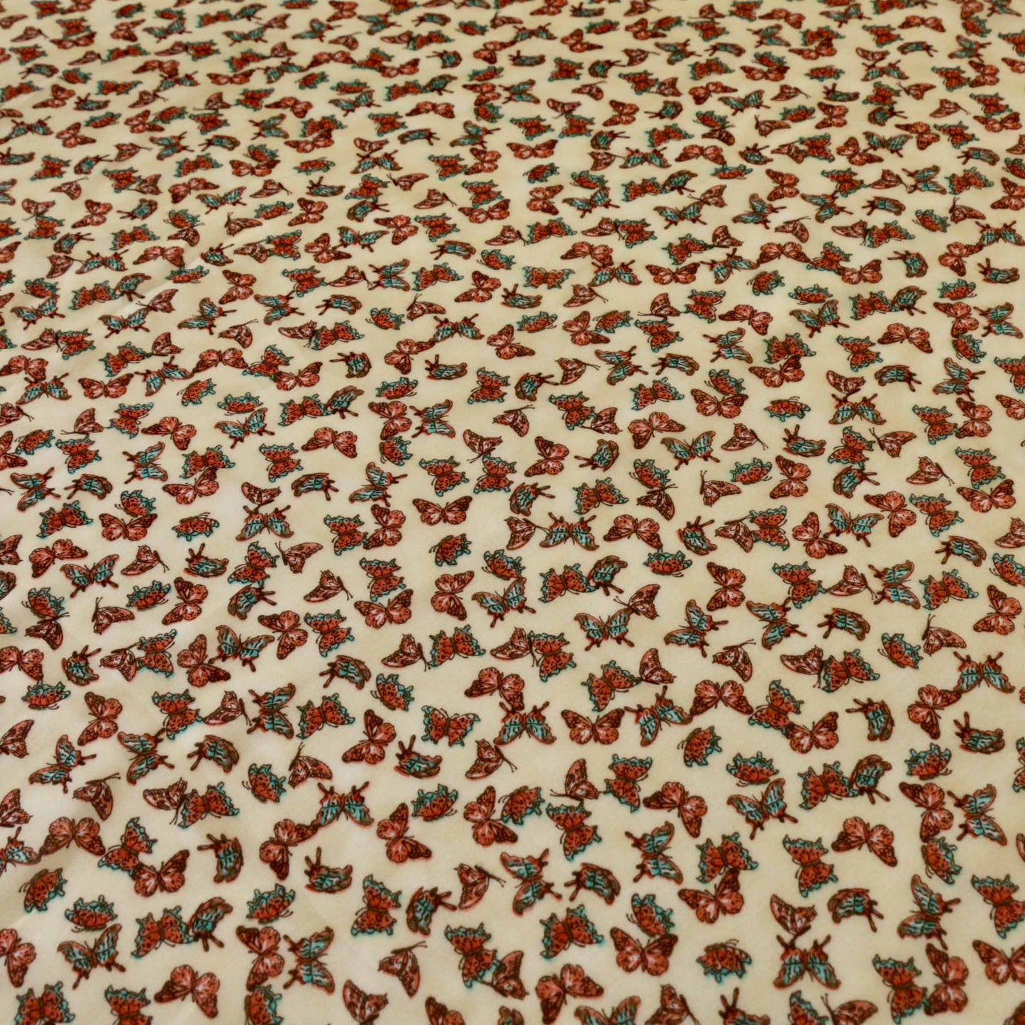 butterfly print on pale beige chiffon polyester dressmaking fabric