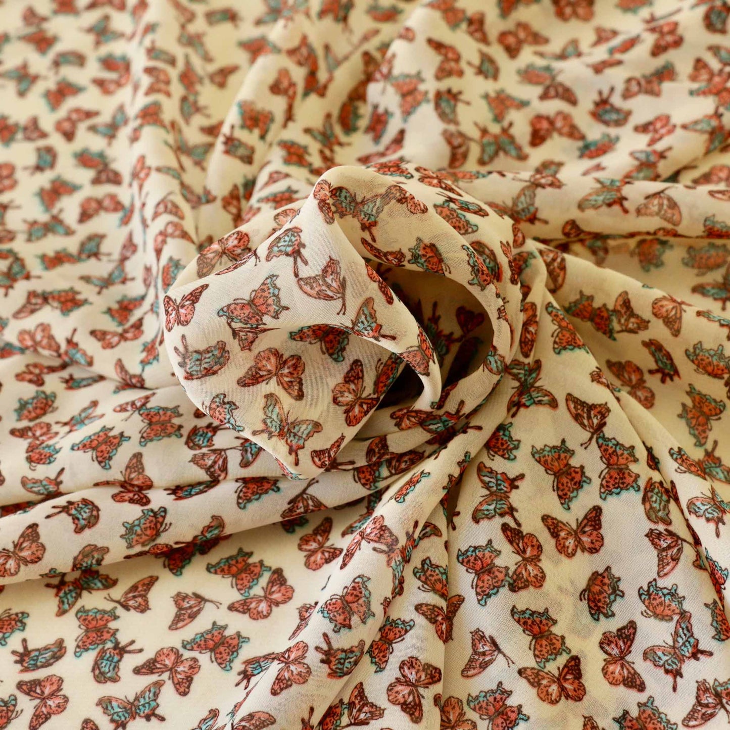 printed butterfly design on synthetic polyester chiffon in pale beige