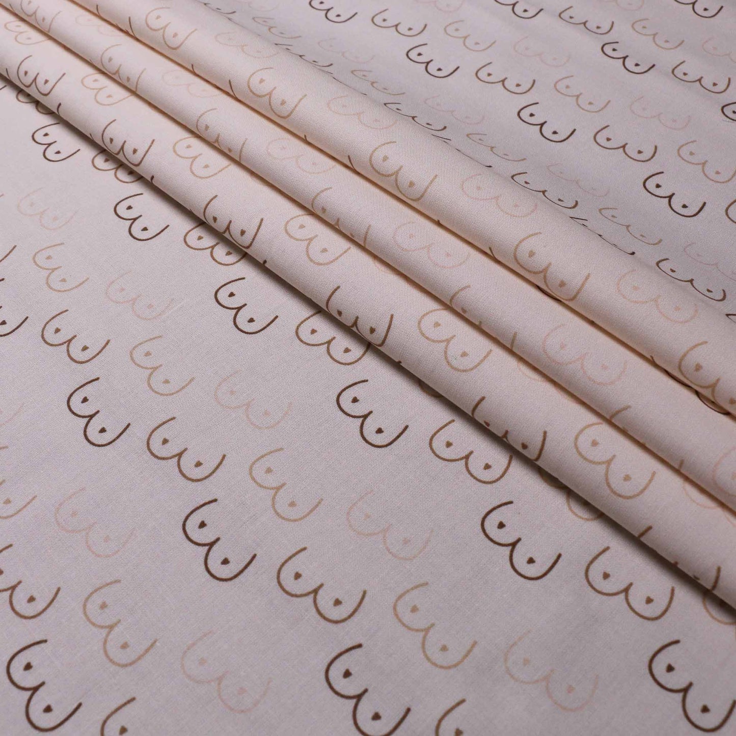 folded cream pure cotton dressmaking fabric with beige boobie print