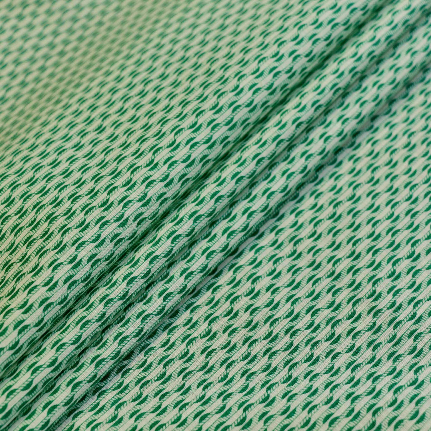 green and white vintage sustainable dressmaking fabric with stripe pattern