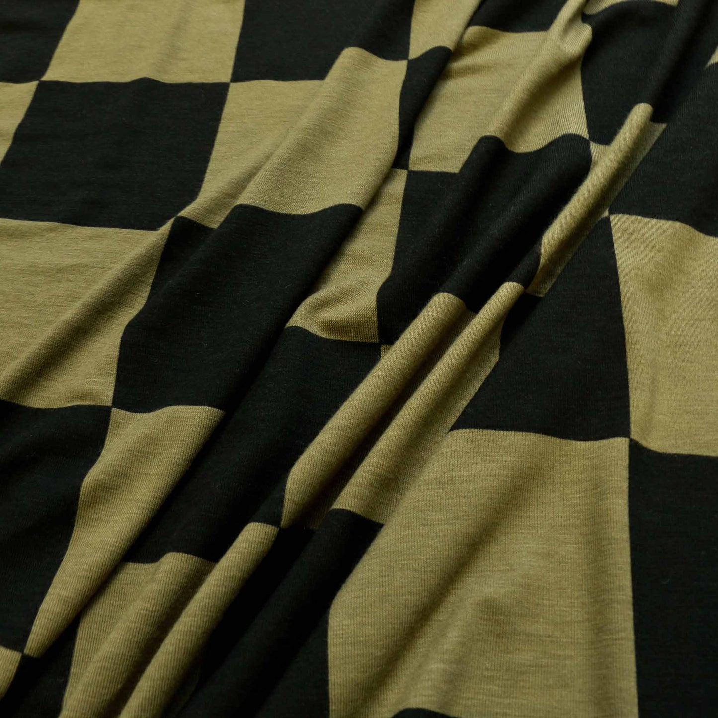 khaki green and black deadstock jersey viscose dressmaking fabric with large check square design