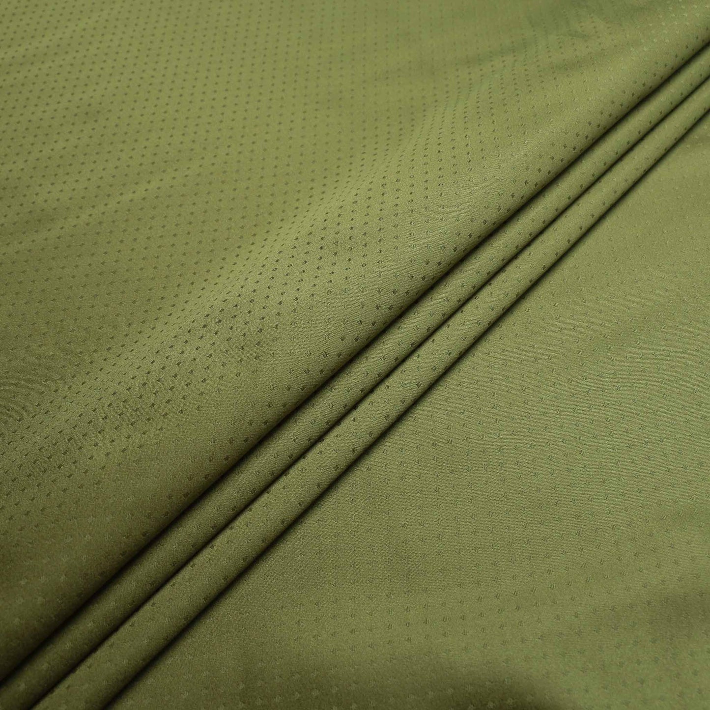 green lining dressmaking fabric on sale with jacquards polka dot pattern