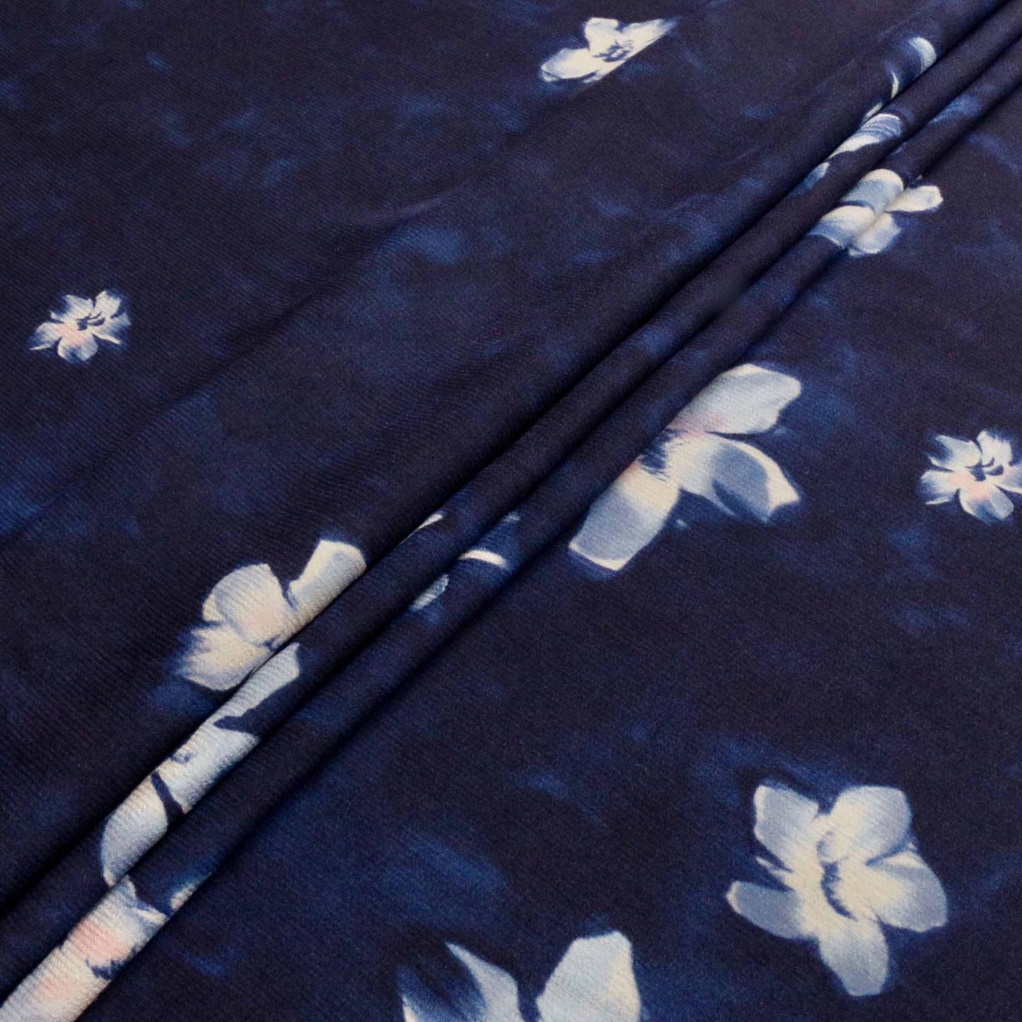 navy blue satin crepe back fabric for dressmaking with floral flower design in white
