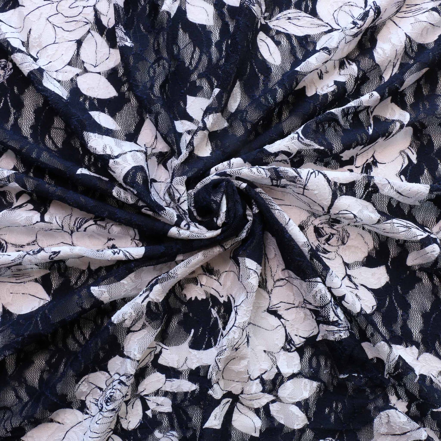 white flowers on delicate navy blue dressmaking lace fabric