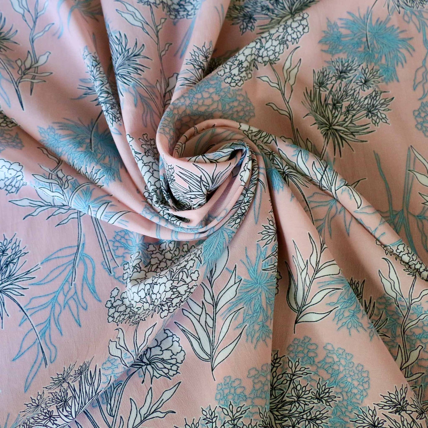 stretchy chiffon polyester dressmaking fabric in pink with white and blue floral print