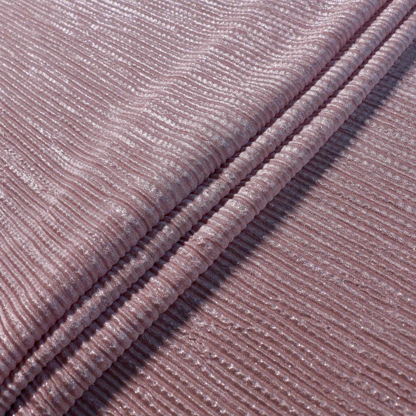 stretchy pink pleated plisse dressmaking fabric with shiny shimmer effect texture