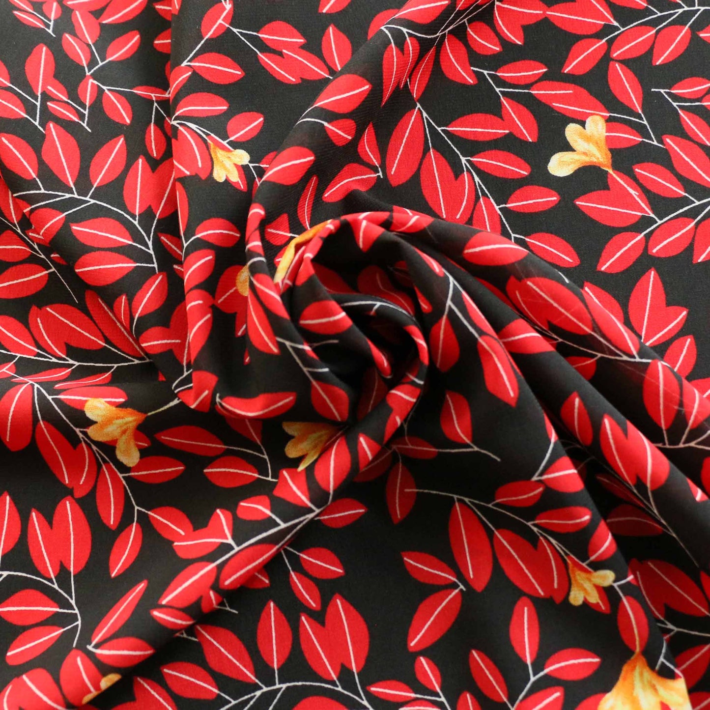 red leaf print on black chiffon polyester dressmaking fabric