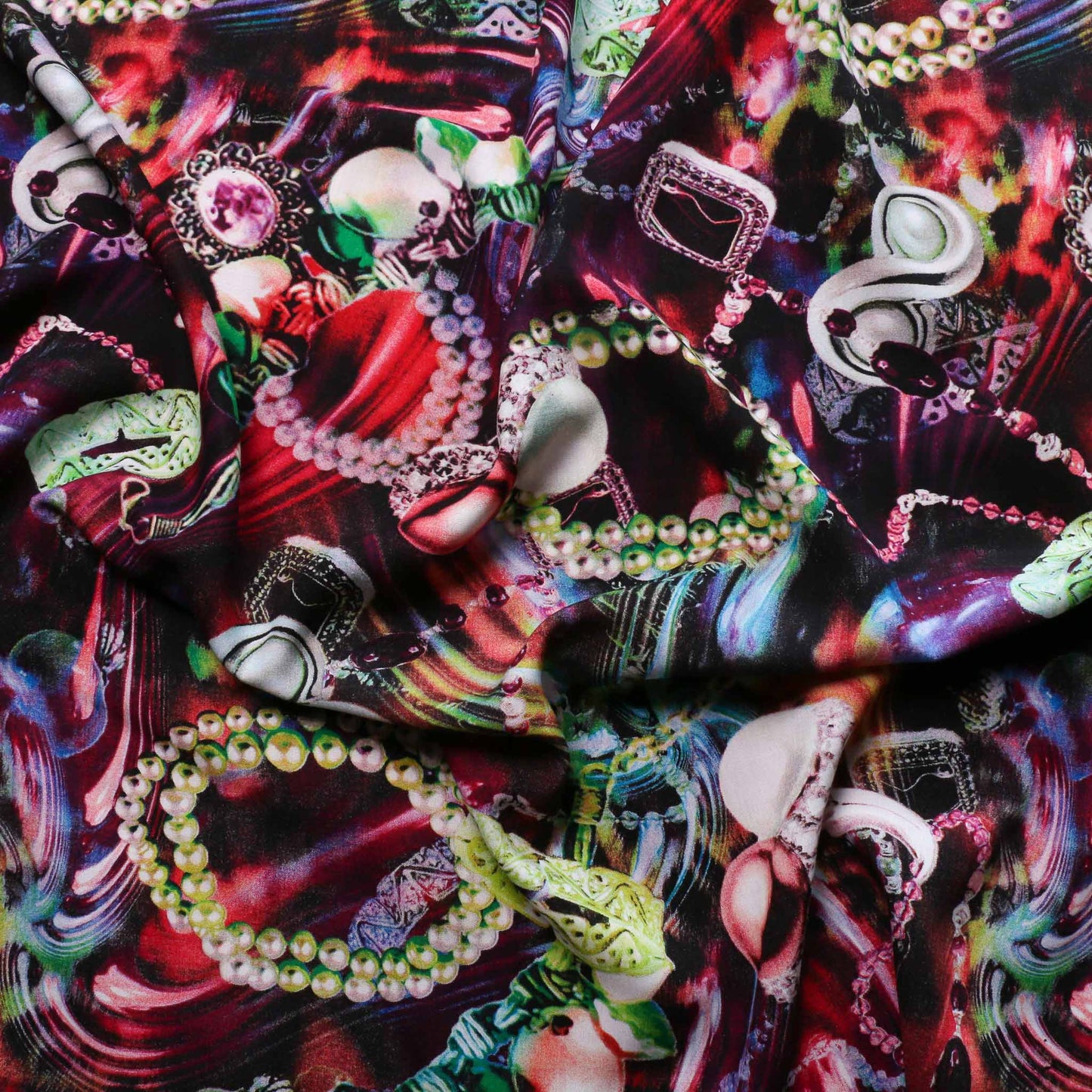 viscose challis dressmaking fabric in pink and red with printed jewellery pattern