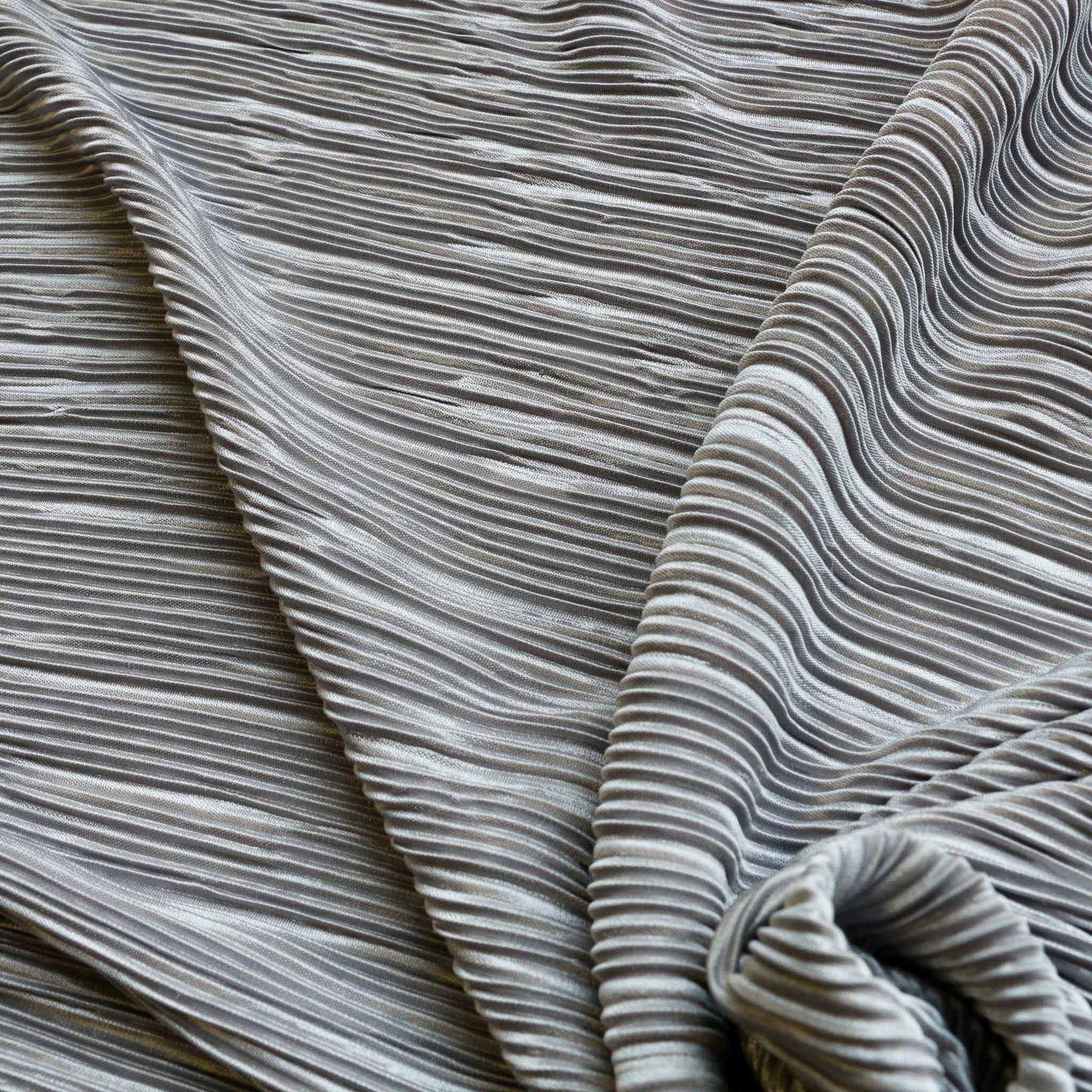 silver plisse dressmaking fabric with pleated design