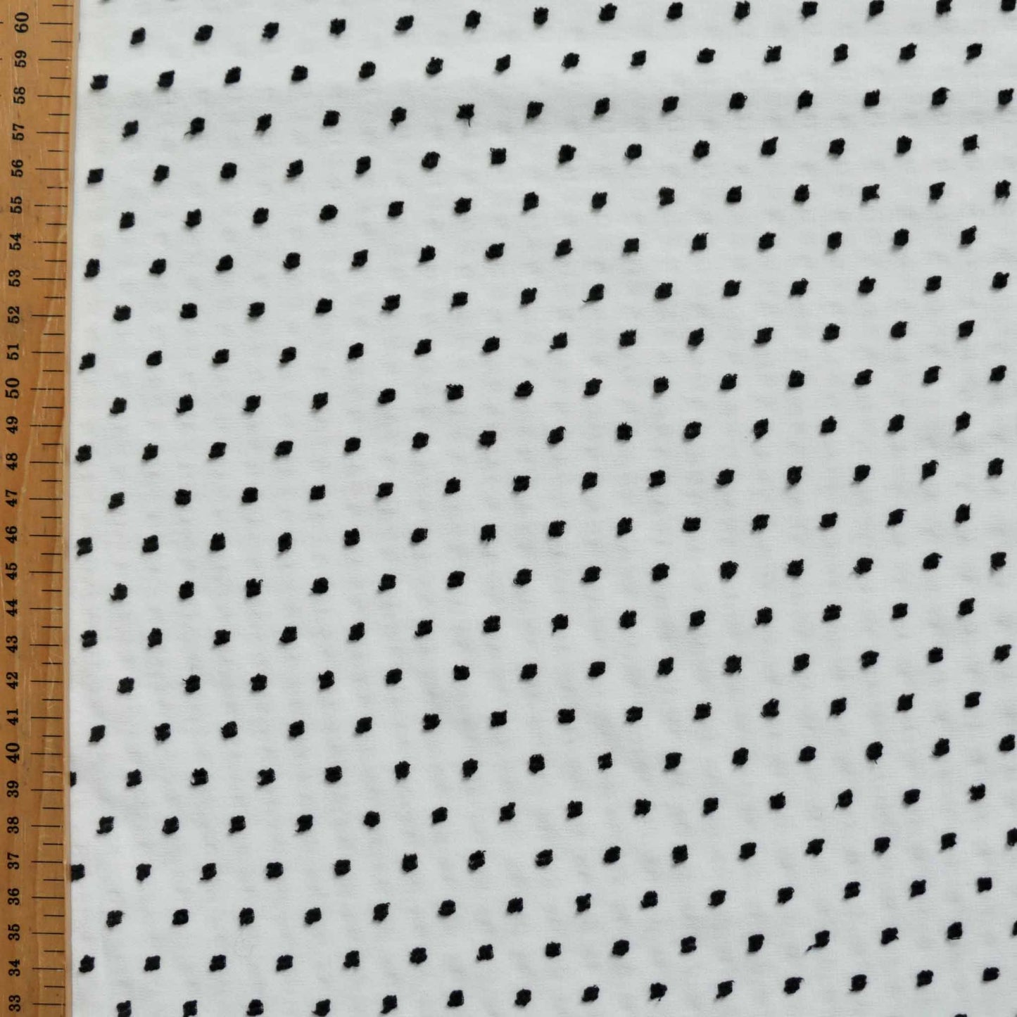 black swiss dot dobby on white chiffon dressmaking fabric