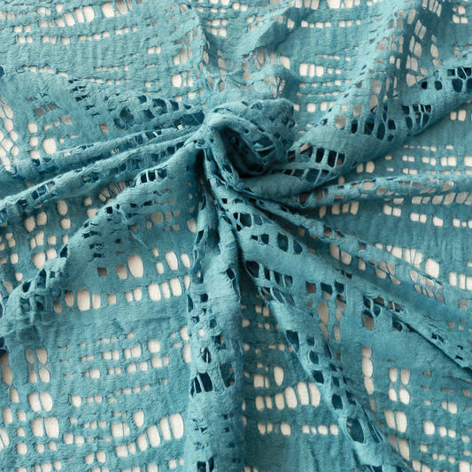 turquoise embroidery lace dressmaking fabric with abstract cutout design