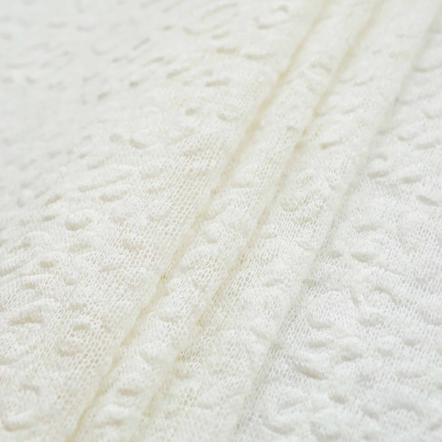 embossed white jersey knit dressmaking fabric
