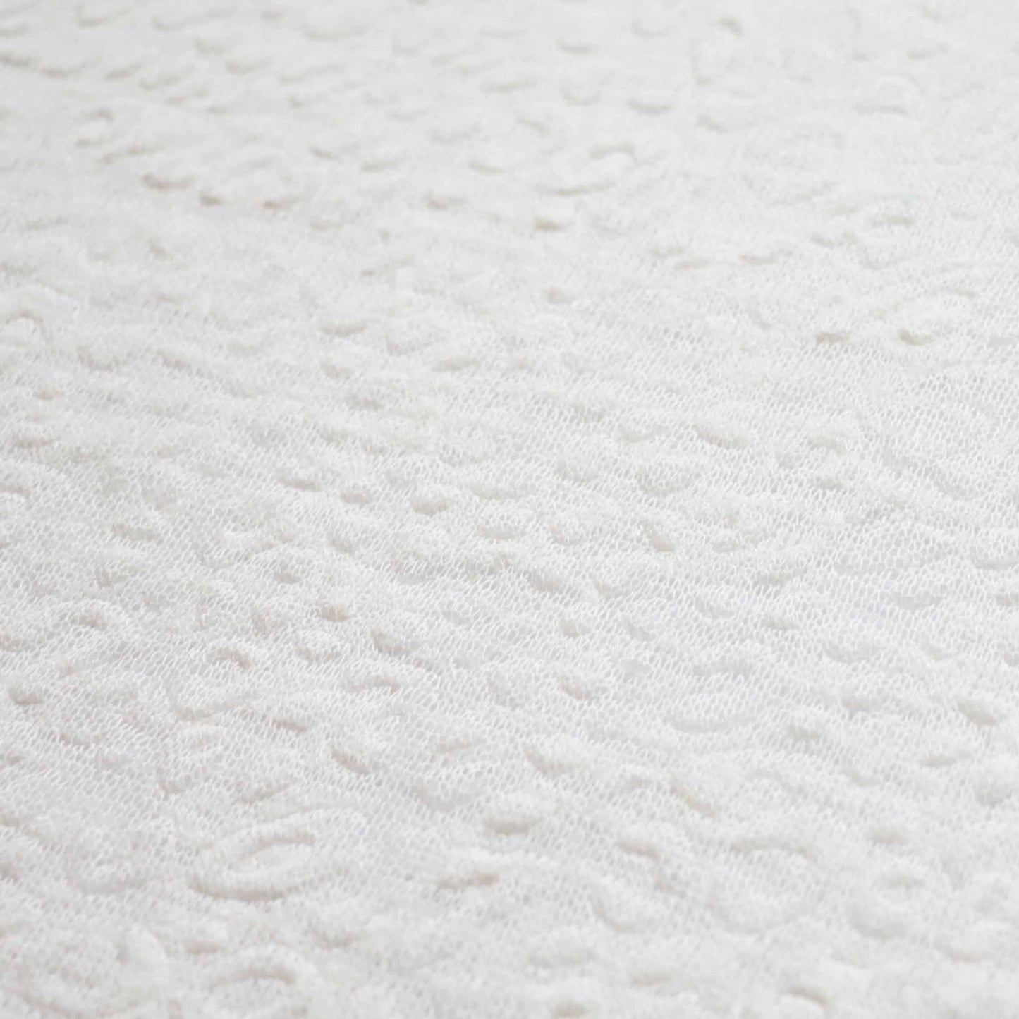 white embossed textured jersey knit dressmaking fabric