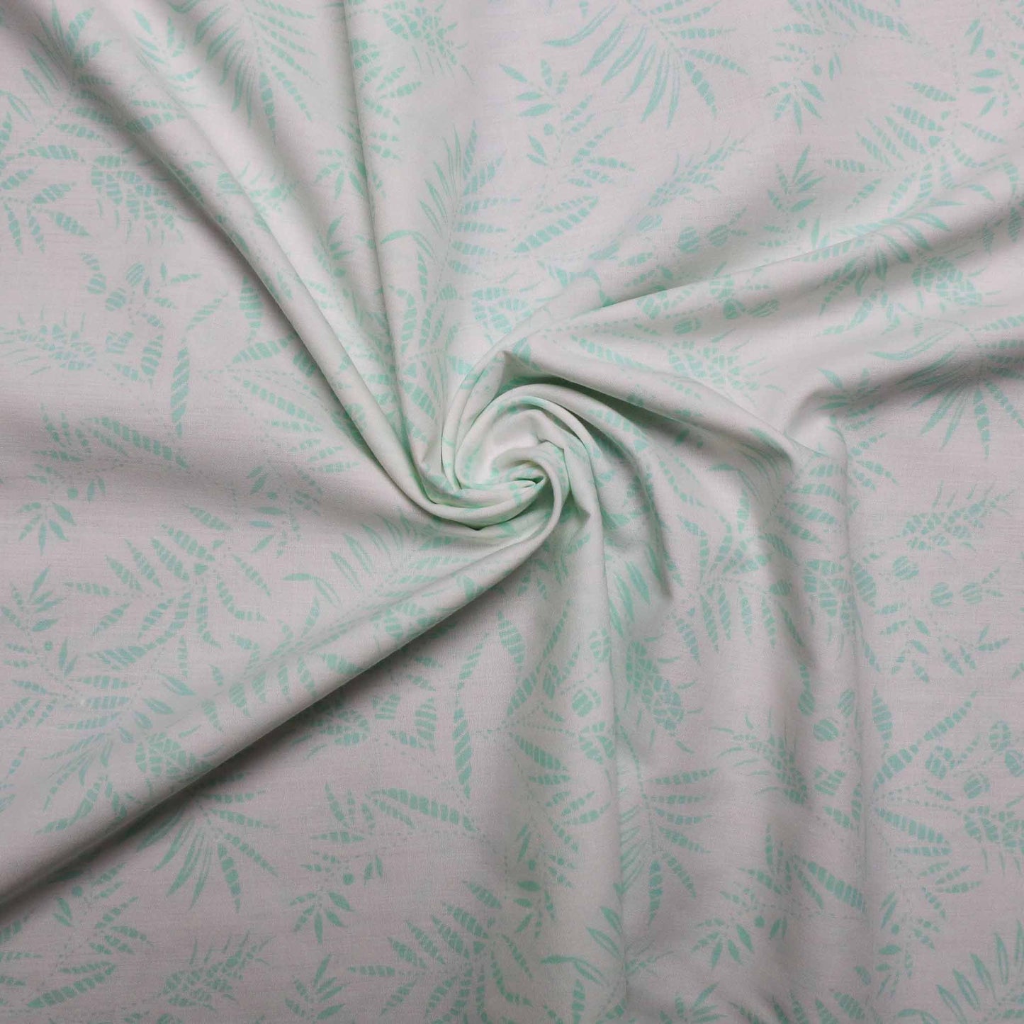 white polycotton dressmaking fabric with mint colour leaves print