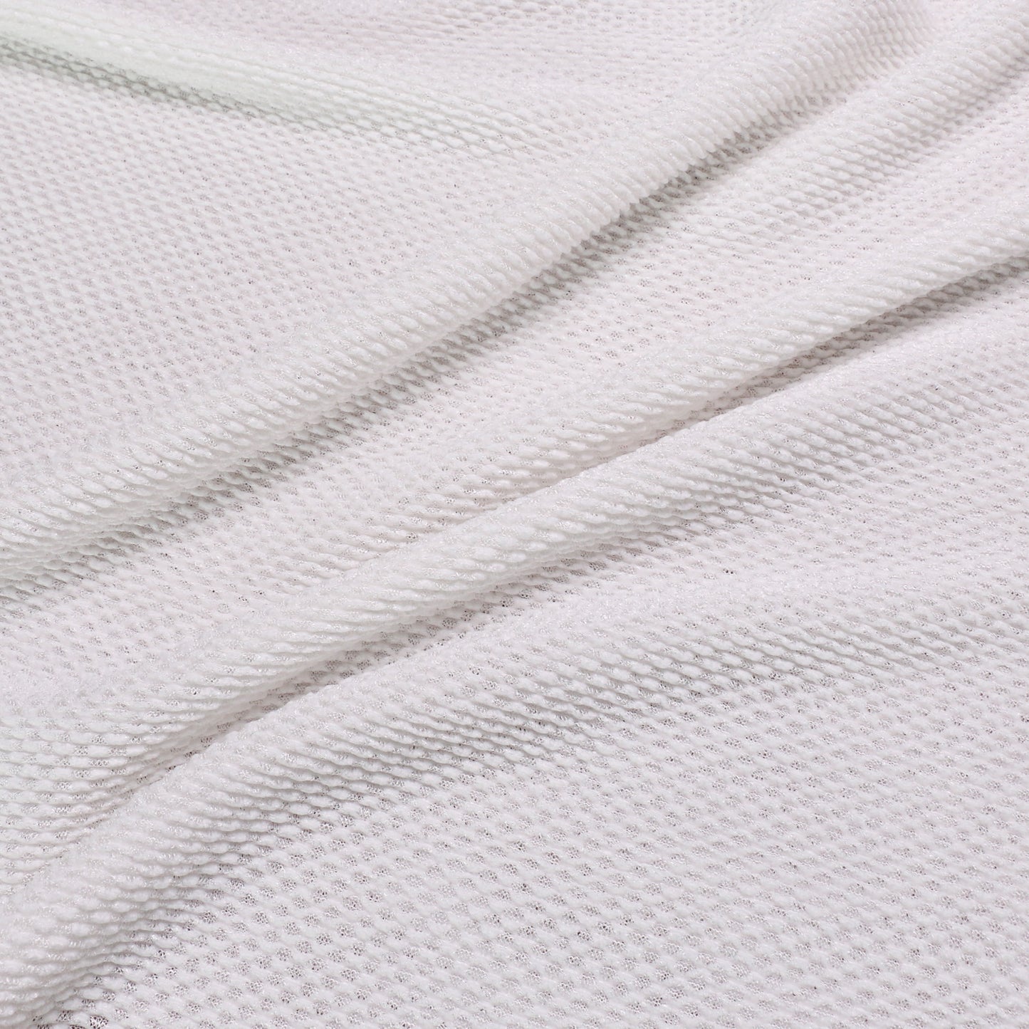 white pleated jersey plisse dressmaking fabric with geometric pattern