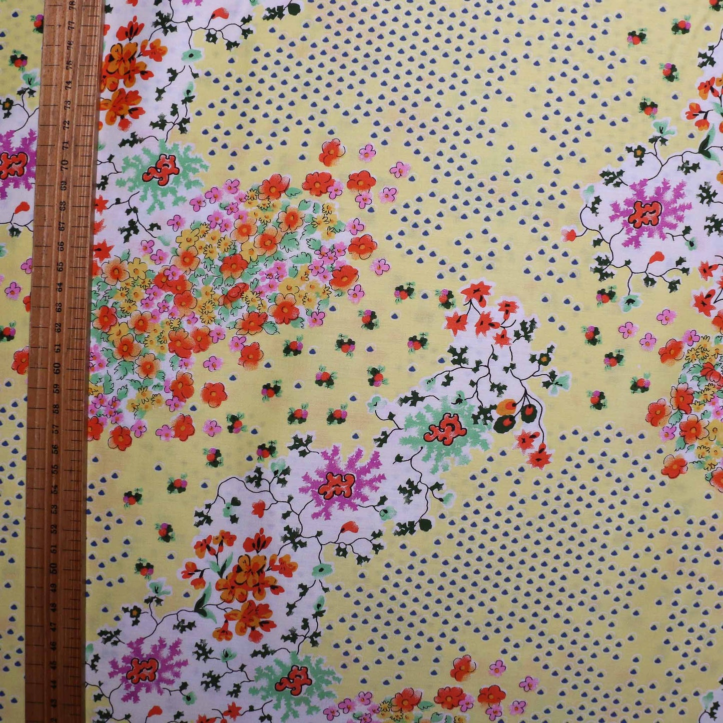 pale yellow cotton lawn dressmaking fabric with multicoloured floral print