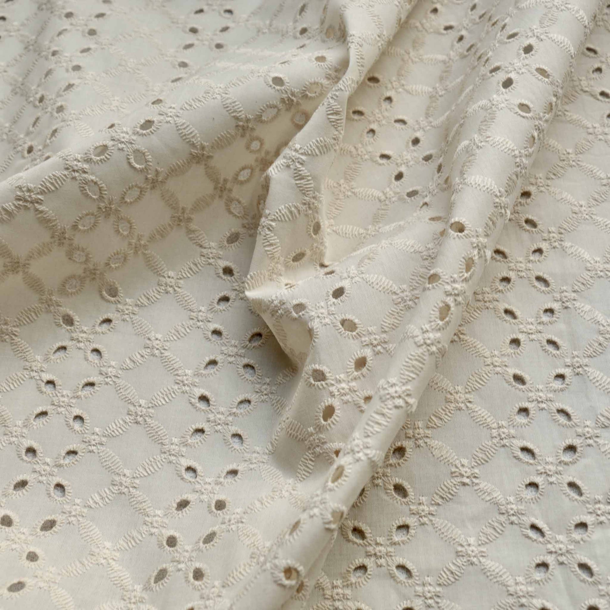 4 hole broad anglaise ivory dressmaking fabric with vanilla embroidery design