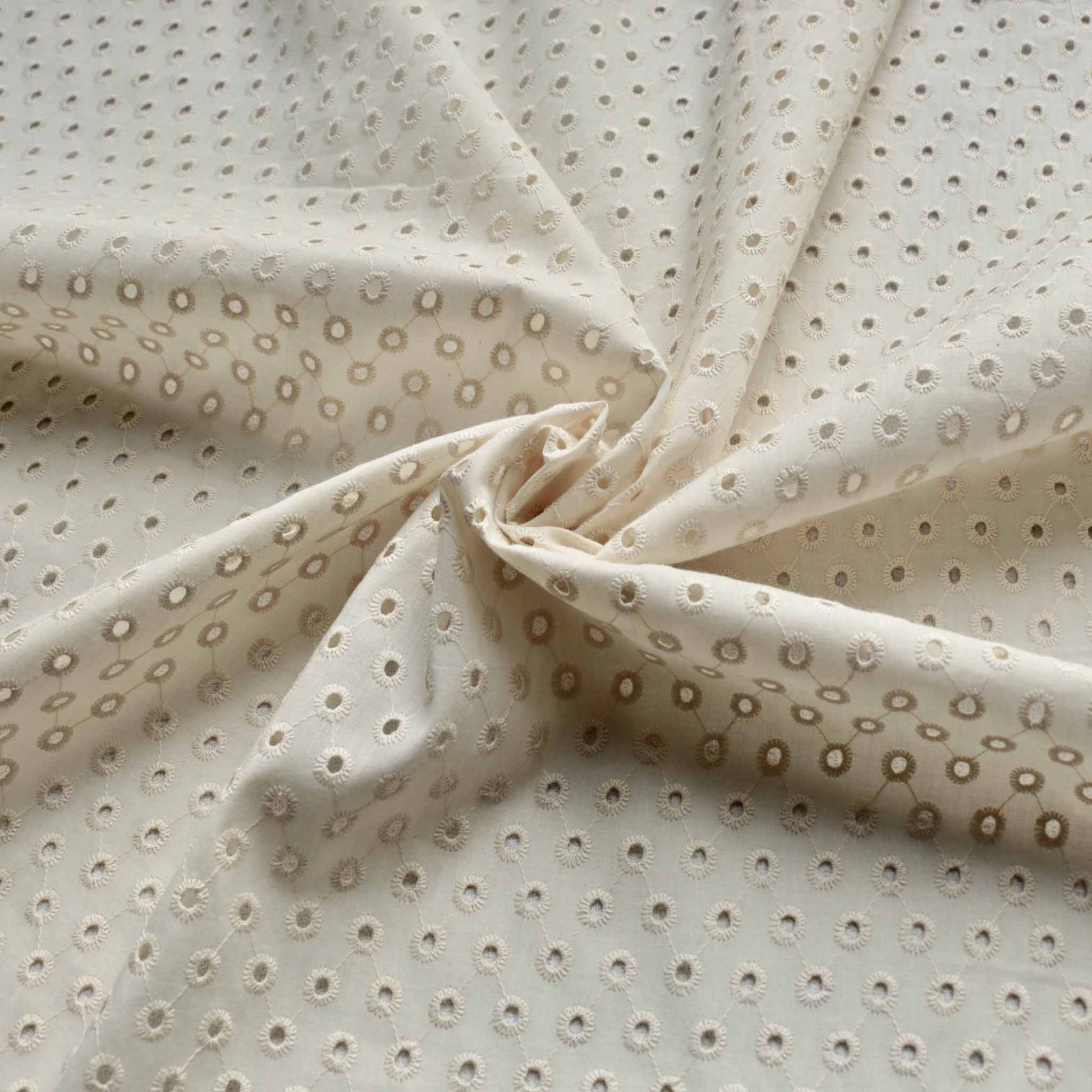 one hole cream broad anglaise dressmaking fabric with classic embroidery design