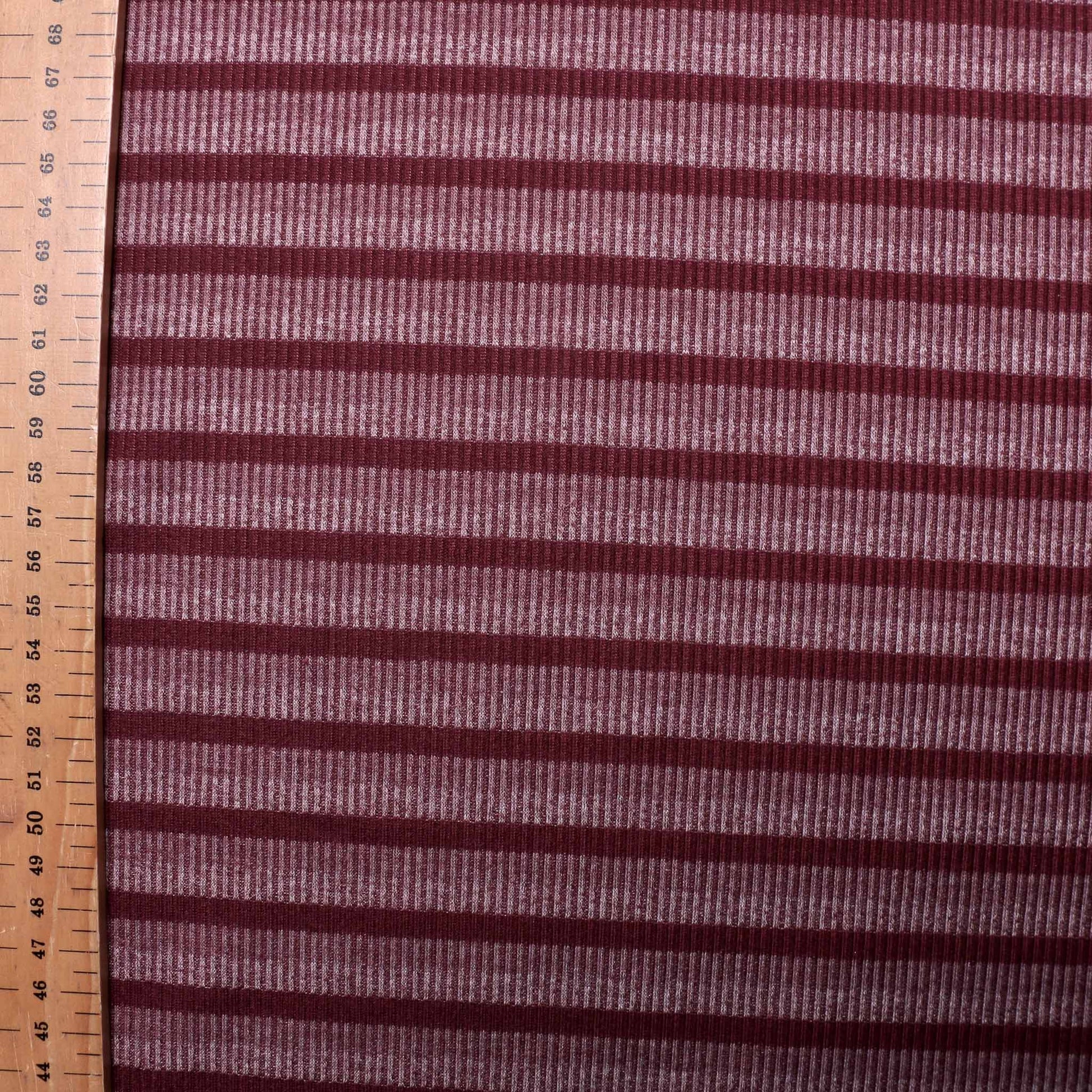 metre jersey rib knit dressmaking fabric with purple and mauve stripe design