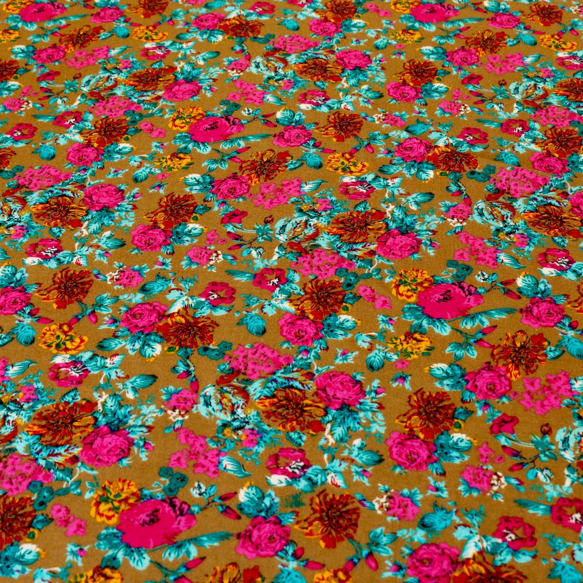 golden viscose rayon challis dressmaking fabric with blue and pink floral design print