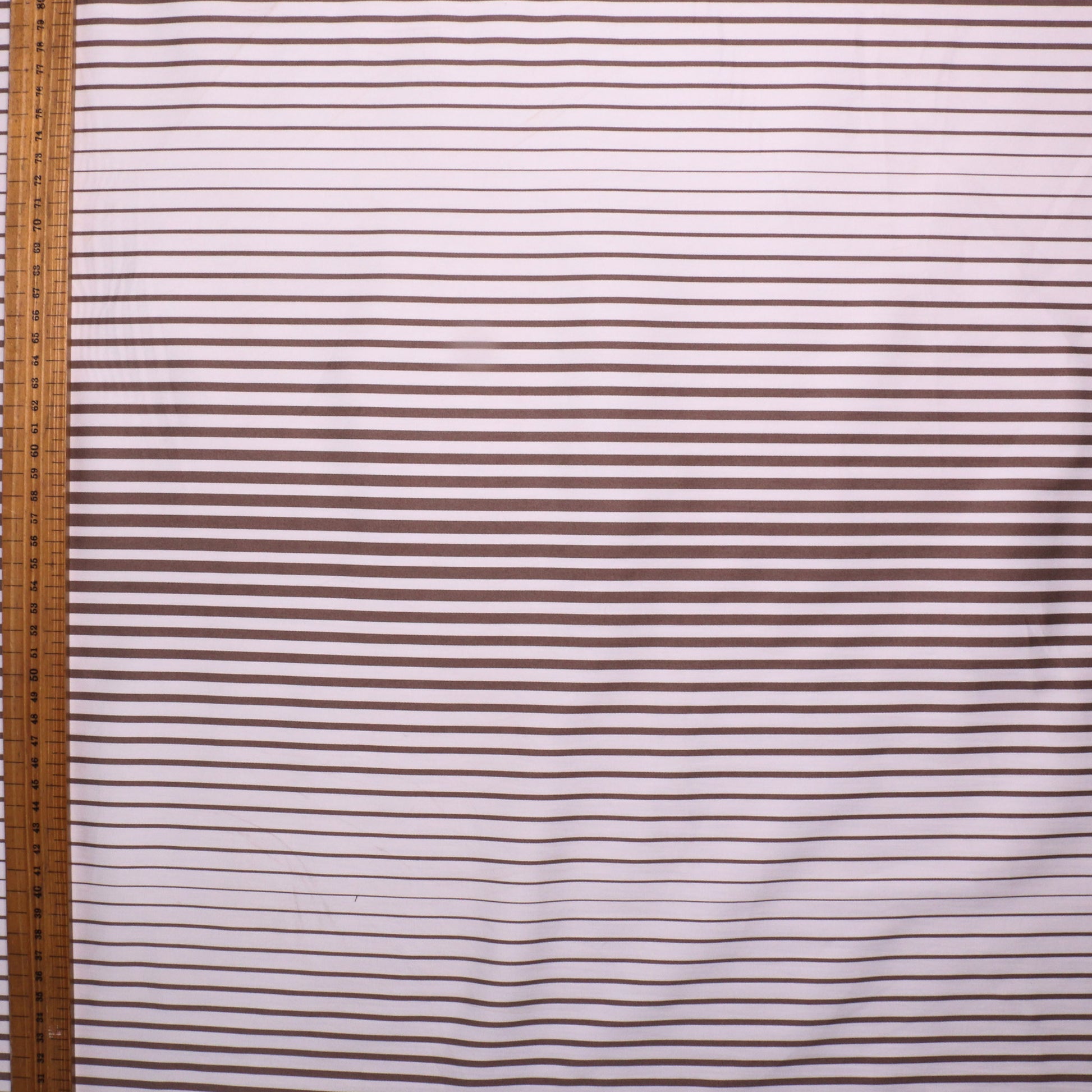metre cotton sateen dressmaking fabric with white and beige stripes