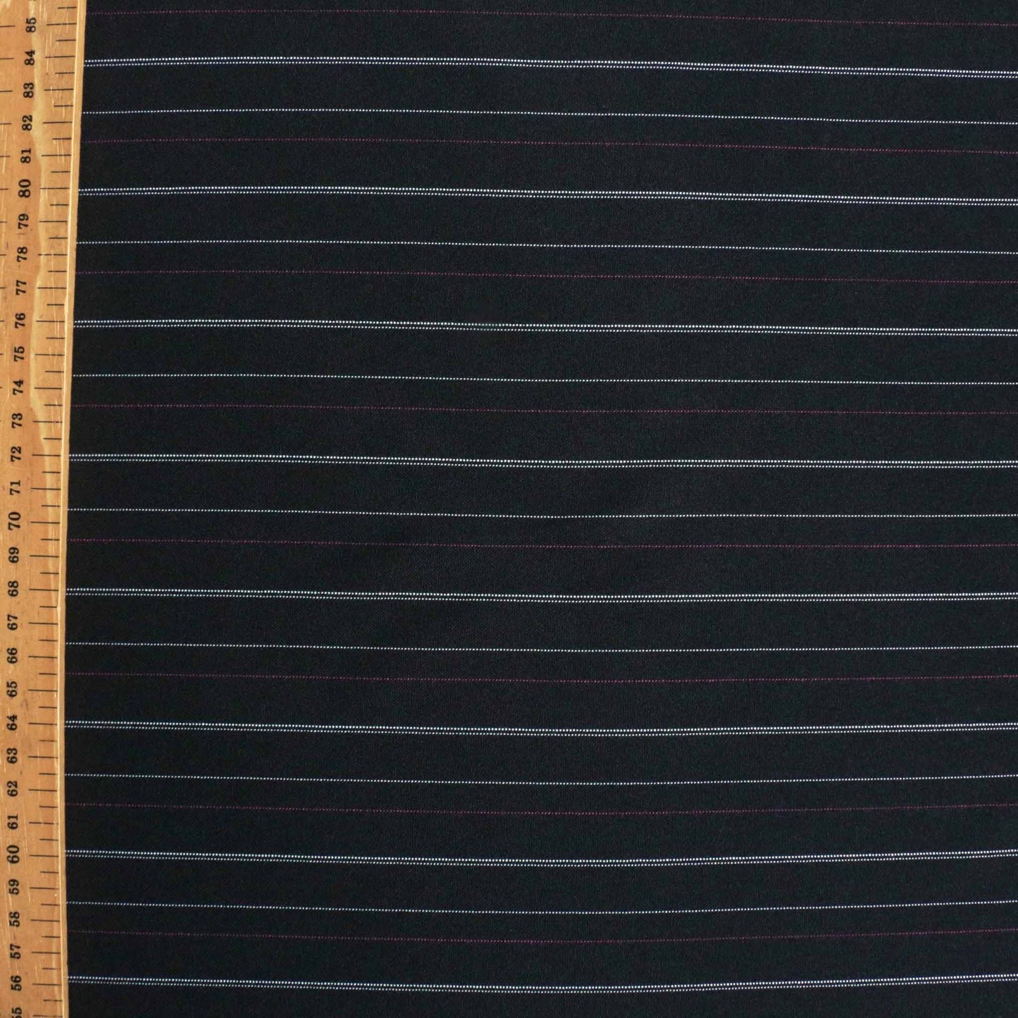 metre black stretchy synthetic dressmaking fabric with pink and white pinstripe