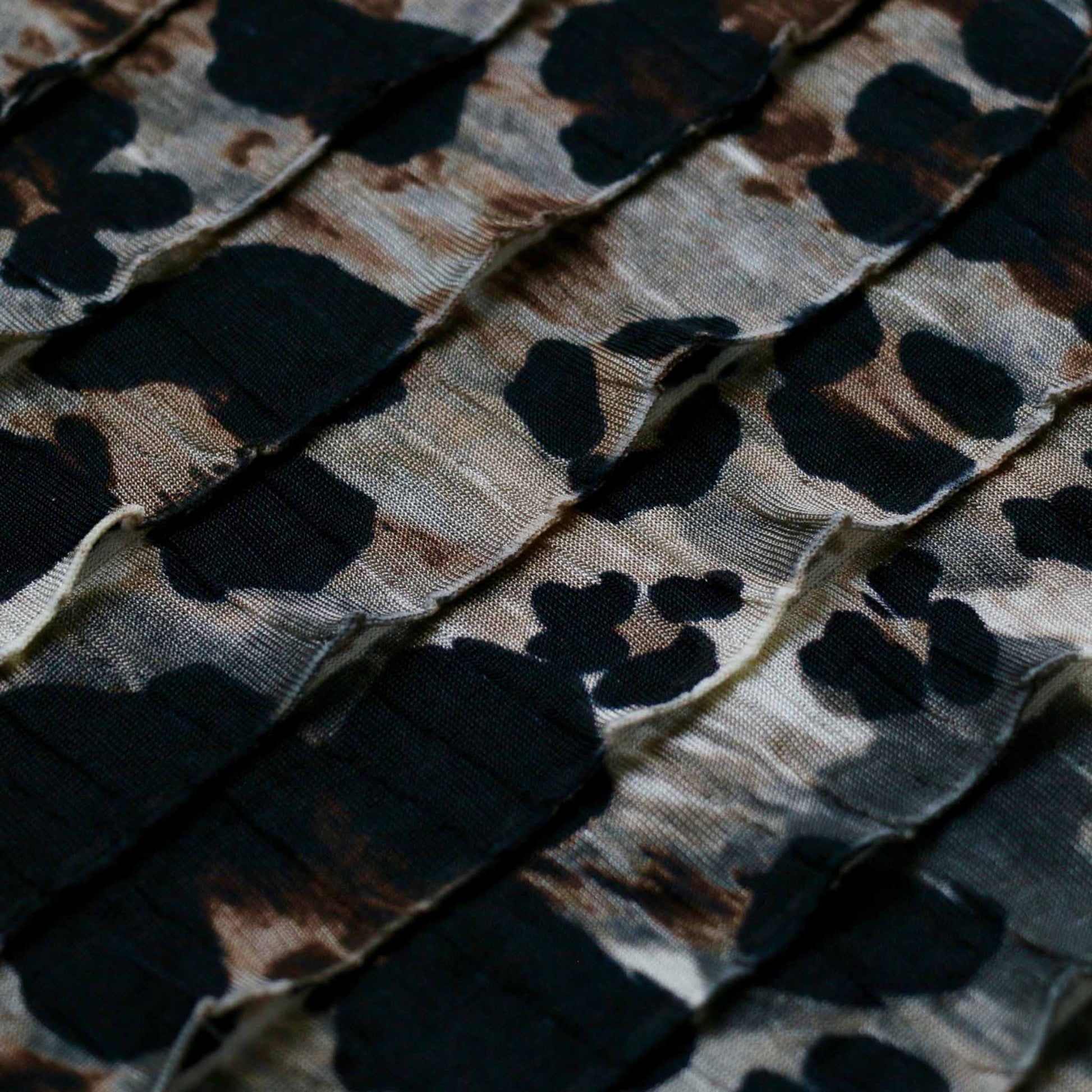 black and beige animal print rara ruffle dressmaking fabric
