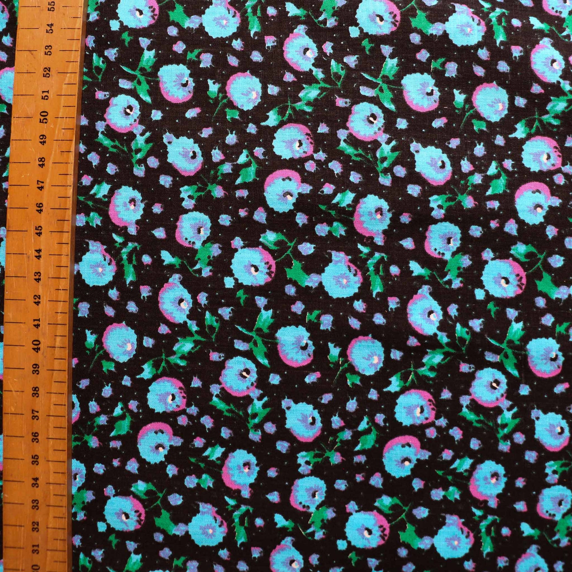 black vintage cotton dressmaking sustainable deadstock fabric with blue pink floral print