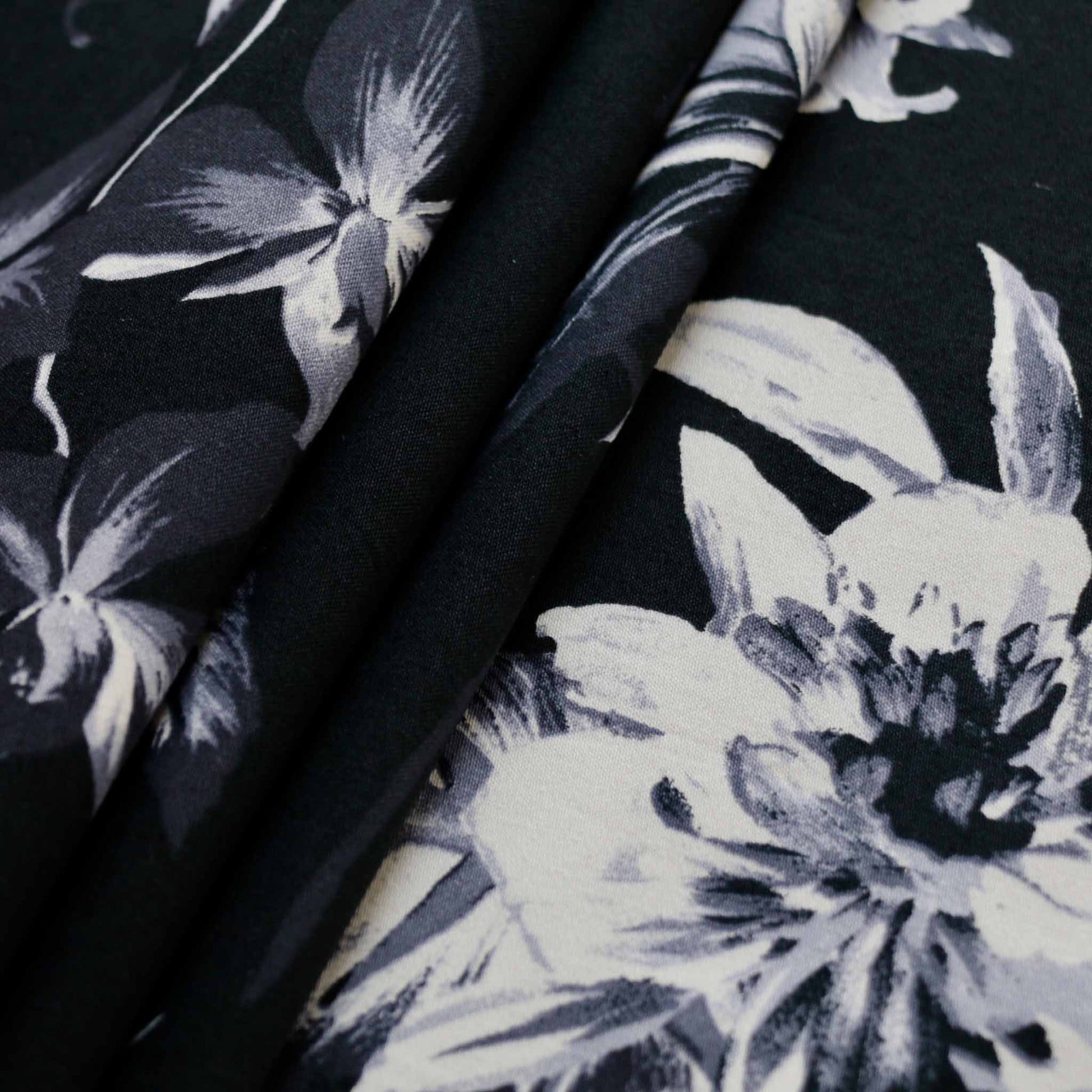 large flower print on black cotton sateen dressmaking stretchy fabric
