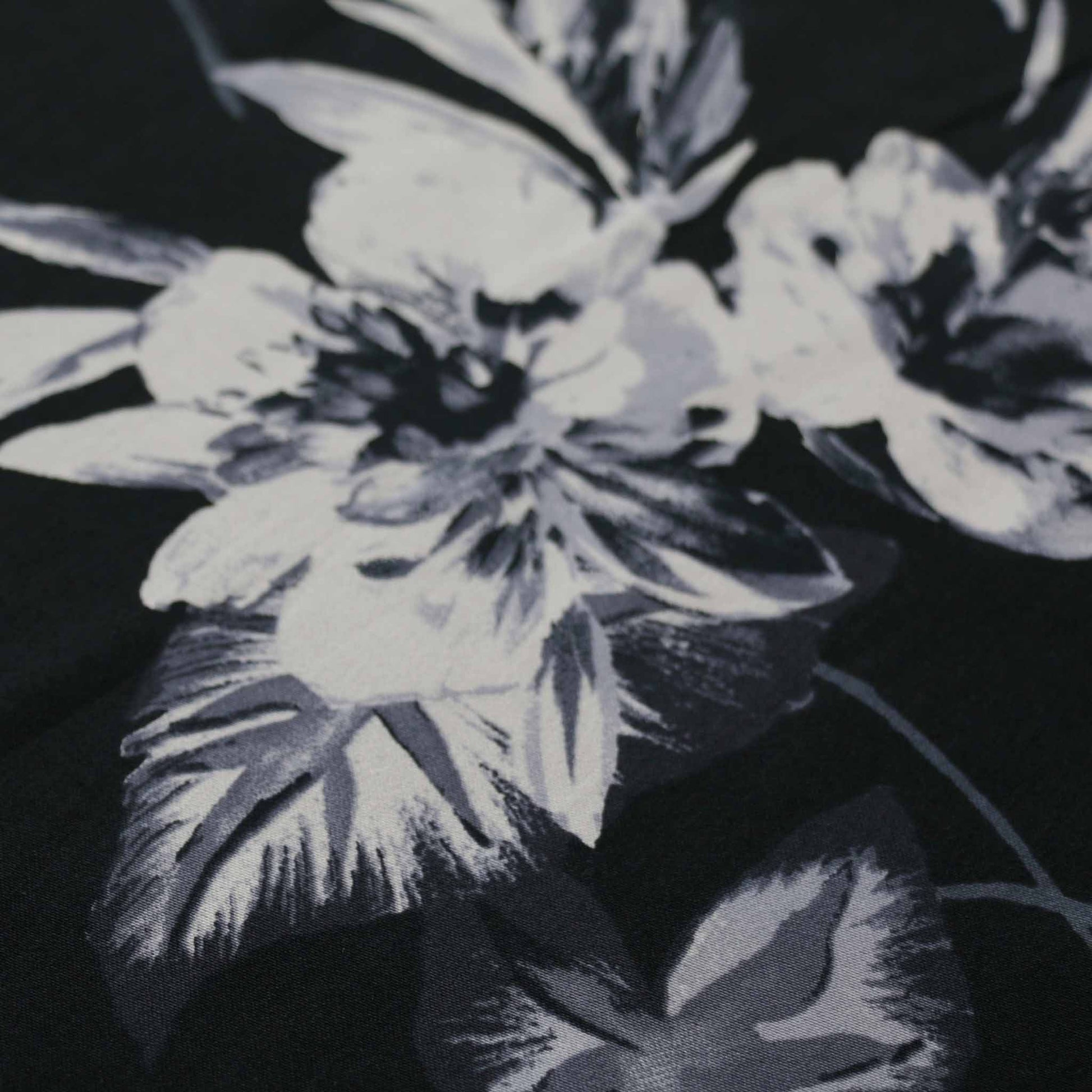 grey flower printed on black cotton sateen stretchy dressmaking fabric
